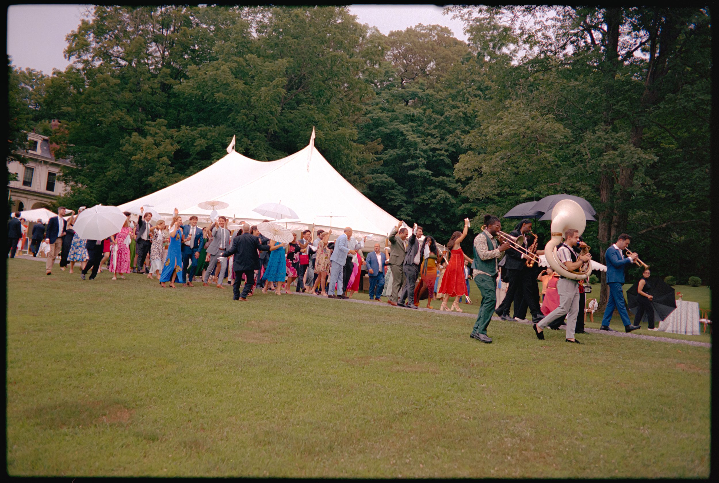 Guests walking across lawn toward tented reception at private estate wedding in Germantown