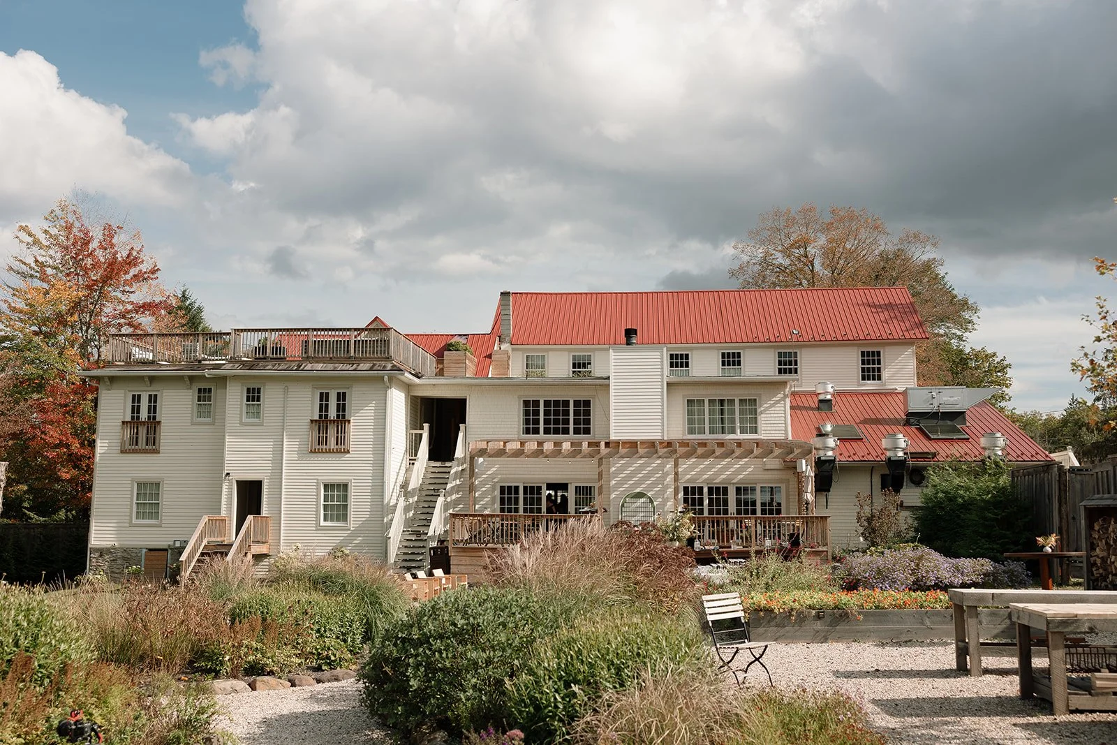 Exterior view of The Henson surrounded by late-season gardens and soft autumn color.