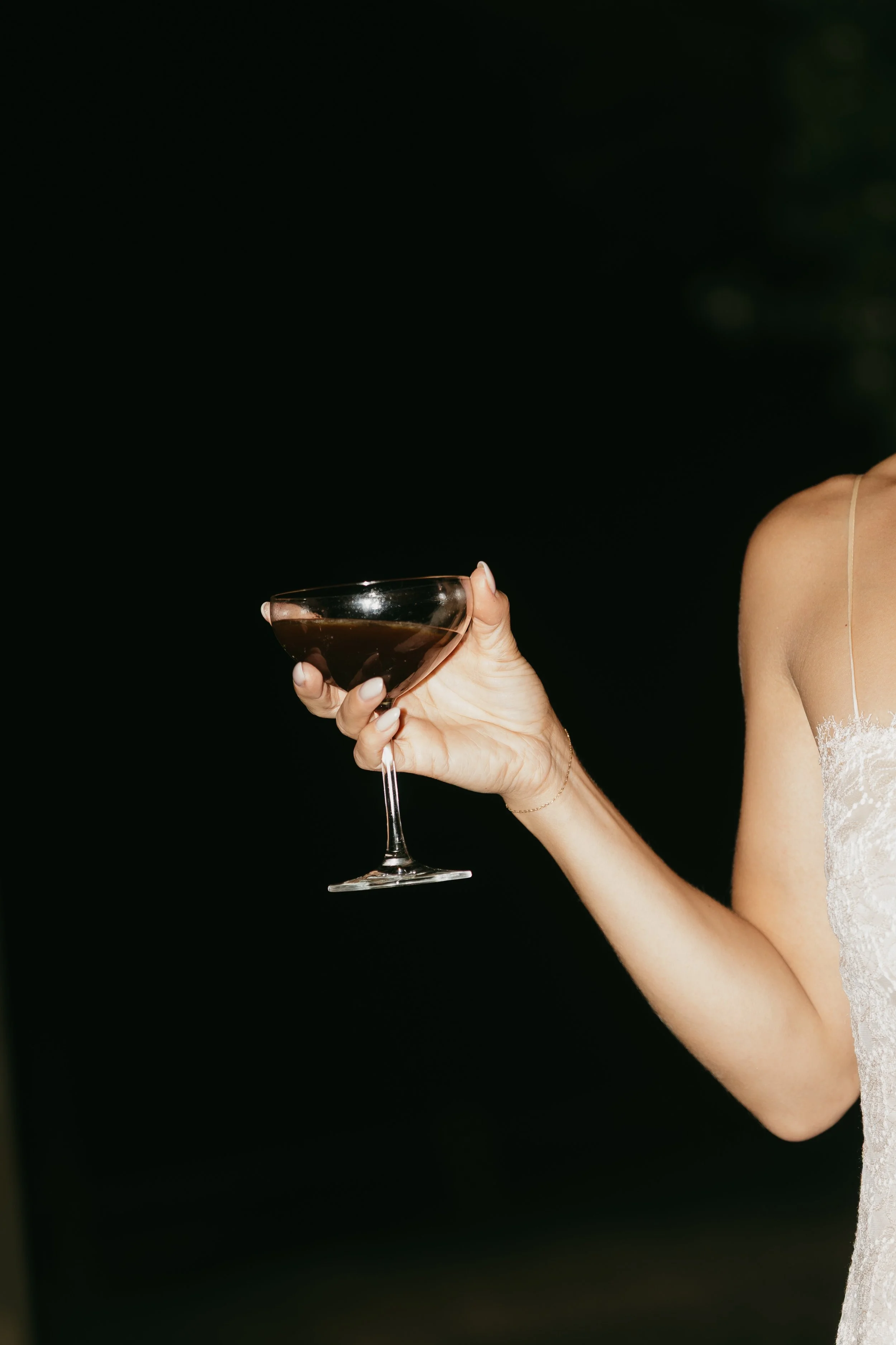 Bride holding cocktail
