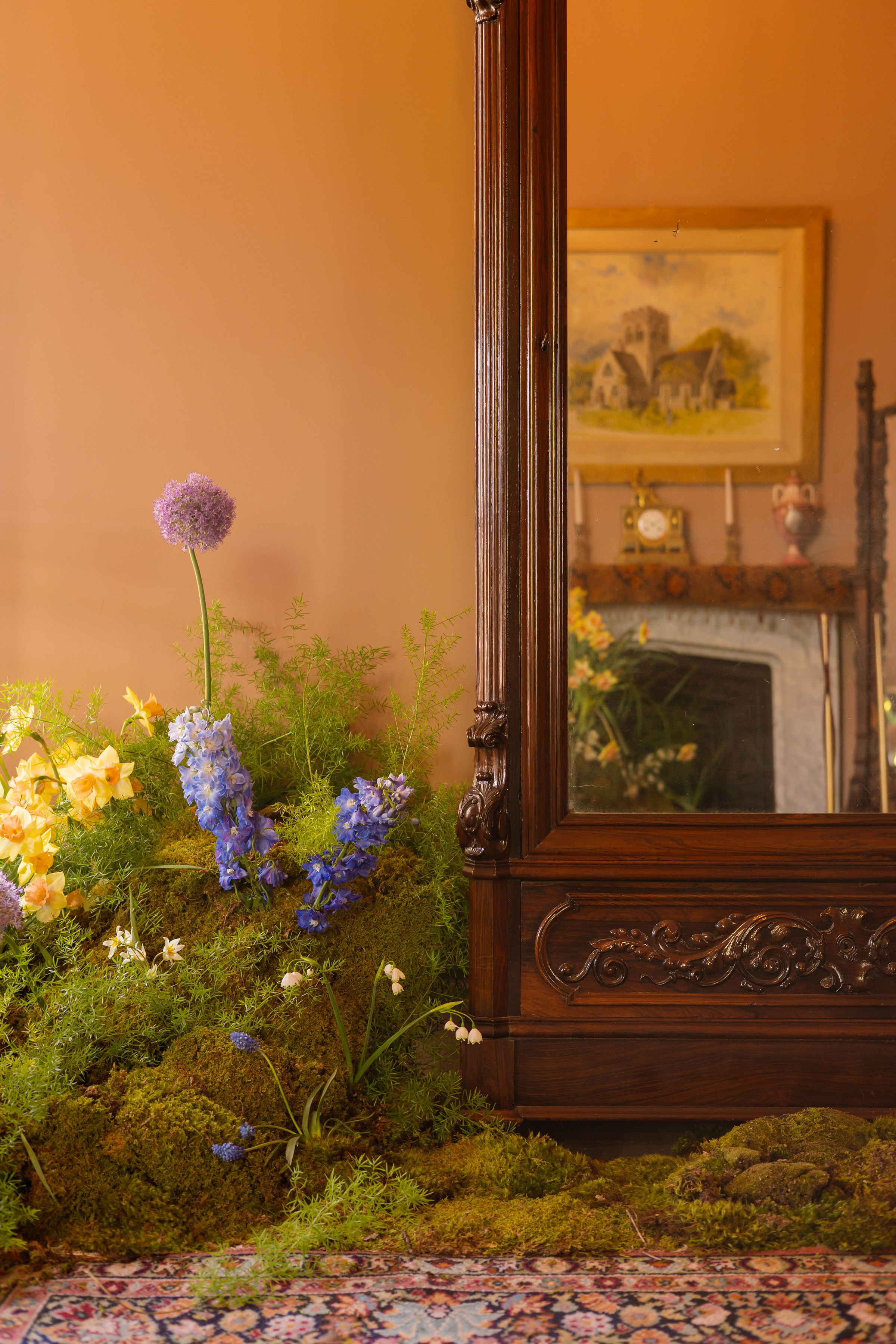 Corner of room featuring textured greenery and delicate flowers
