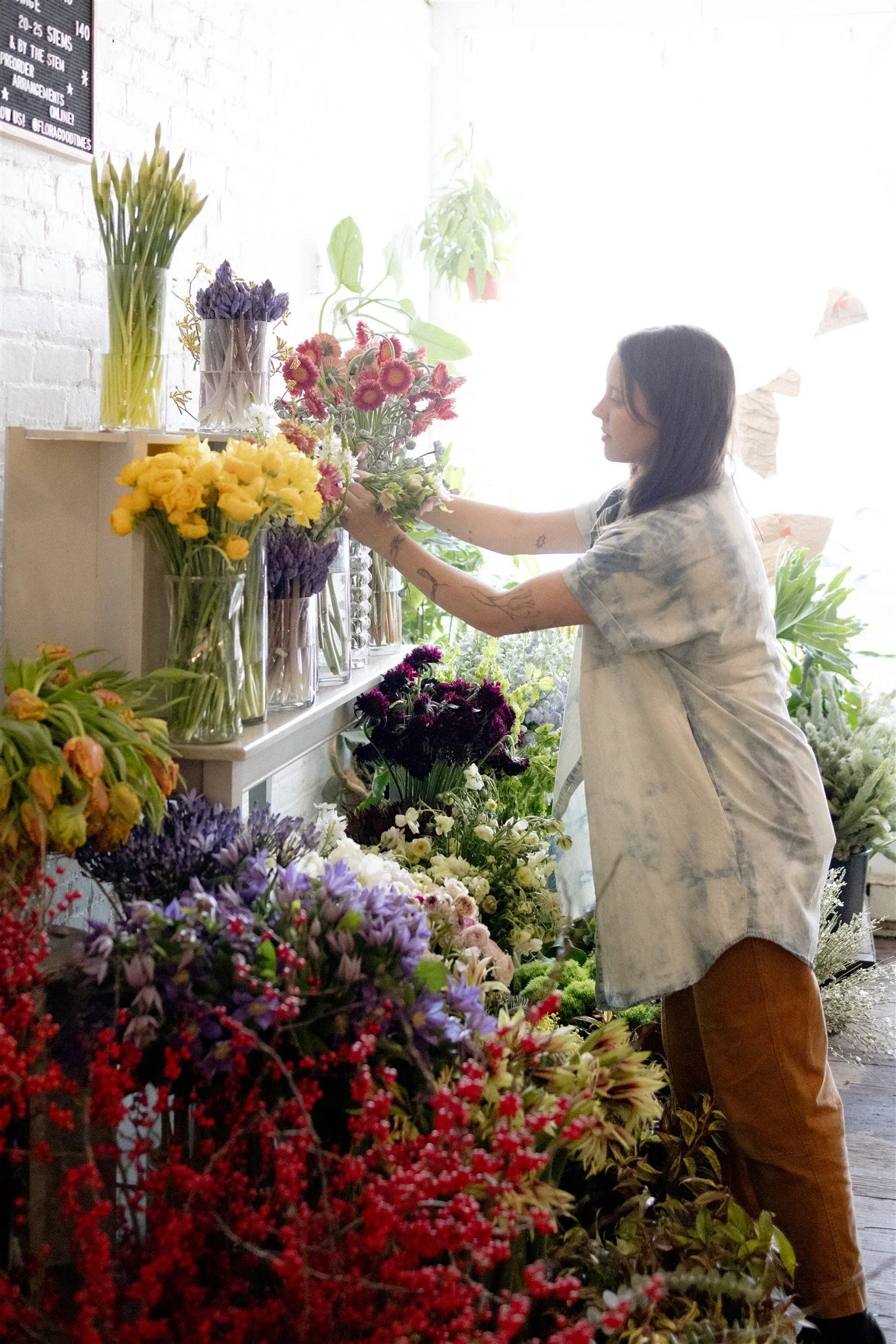 Corinne Bryson selecting fresh flowers for arrangements at Flora Good Times, a Hudson Valley florist.