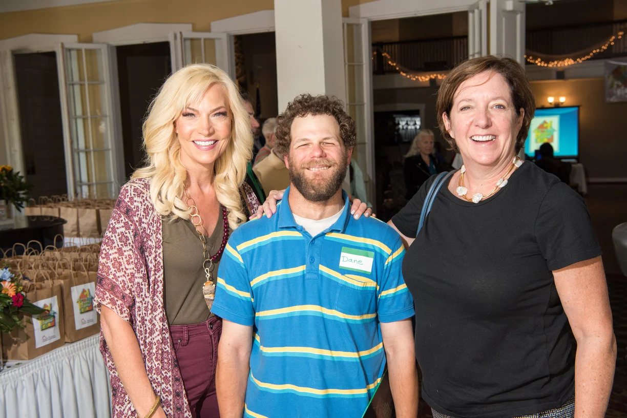 Rush Homes staff, supporters, and tenants come together at an event.