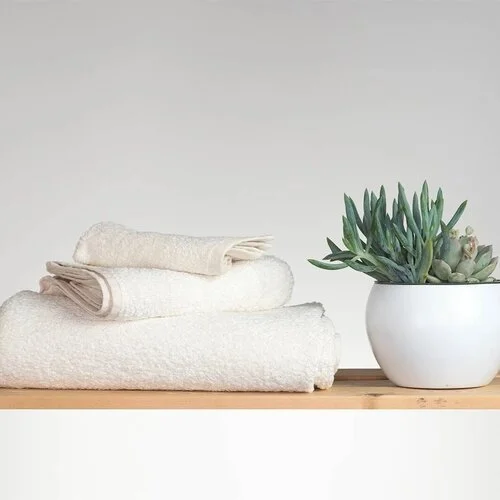 Stack of resuable towels to organize your bathroom to be more zero waste