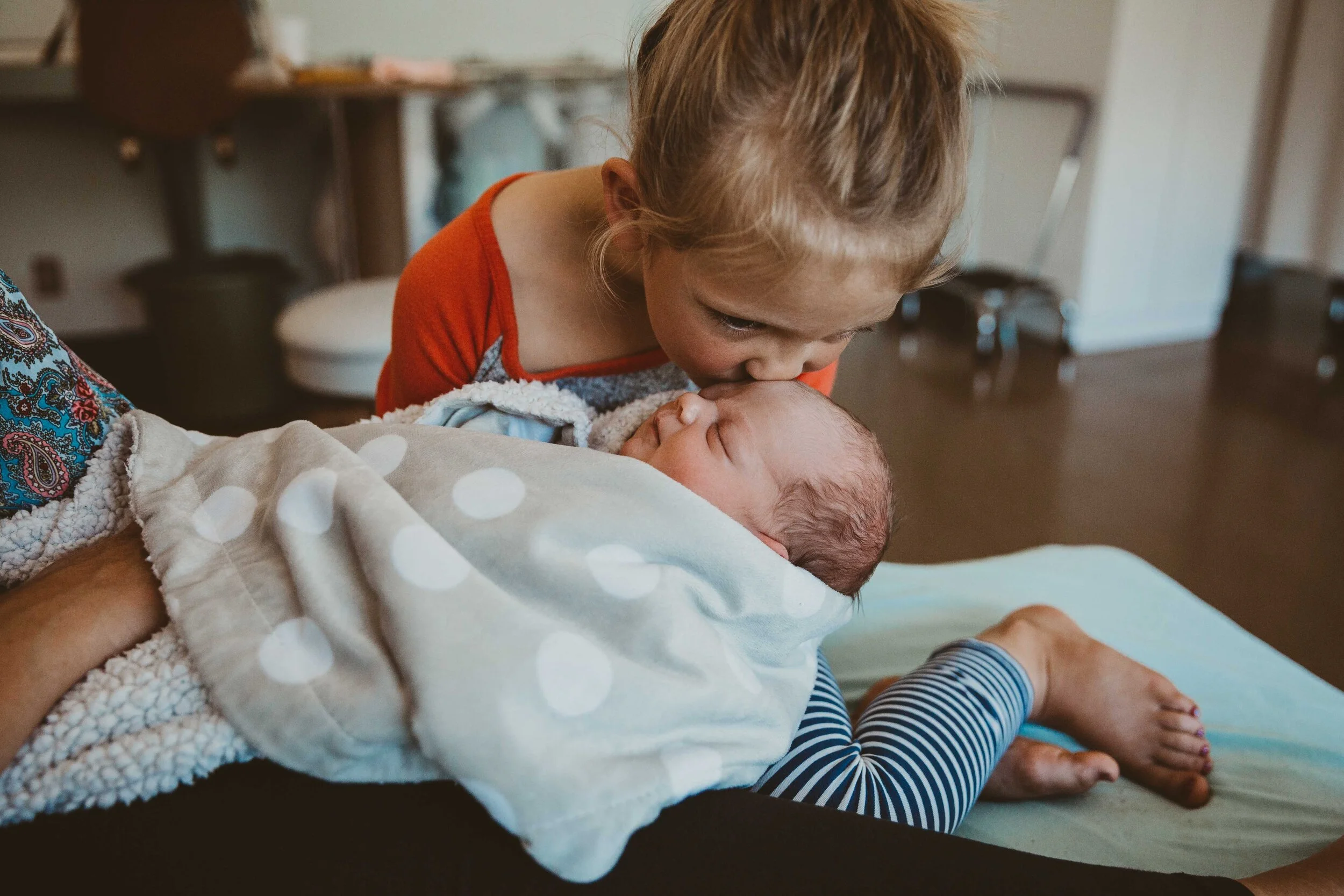  Kiss for a new sister documented during a smithers hospital newborn session. 