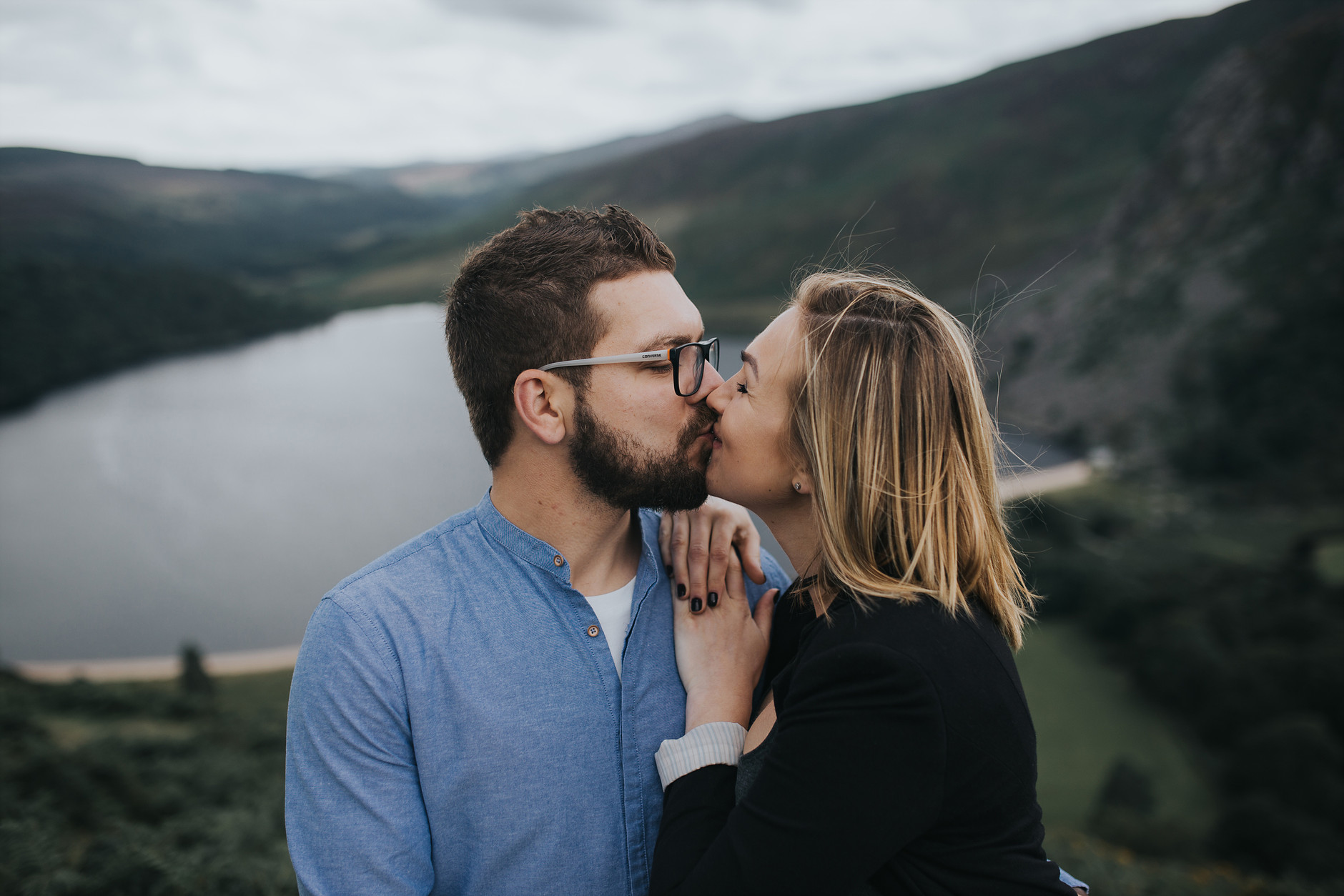 Close-up of couple kissing and smiling in front of the lake : love