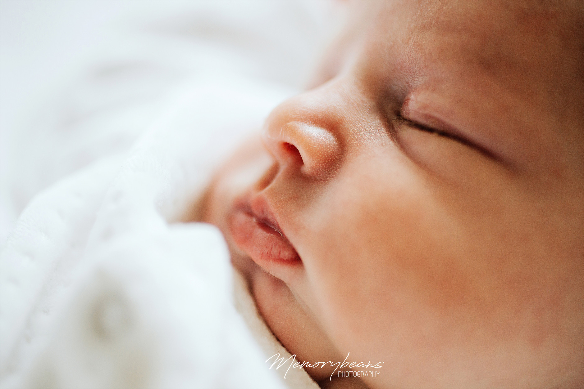 Detail of sleeping newborn baby’s lips and nose