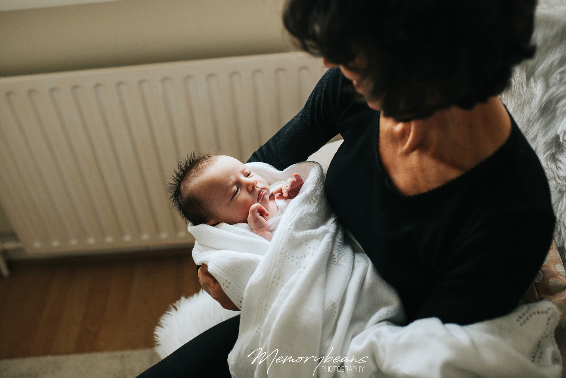 Grandmother holding newborn baby in her arms