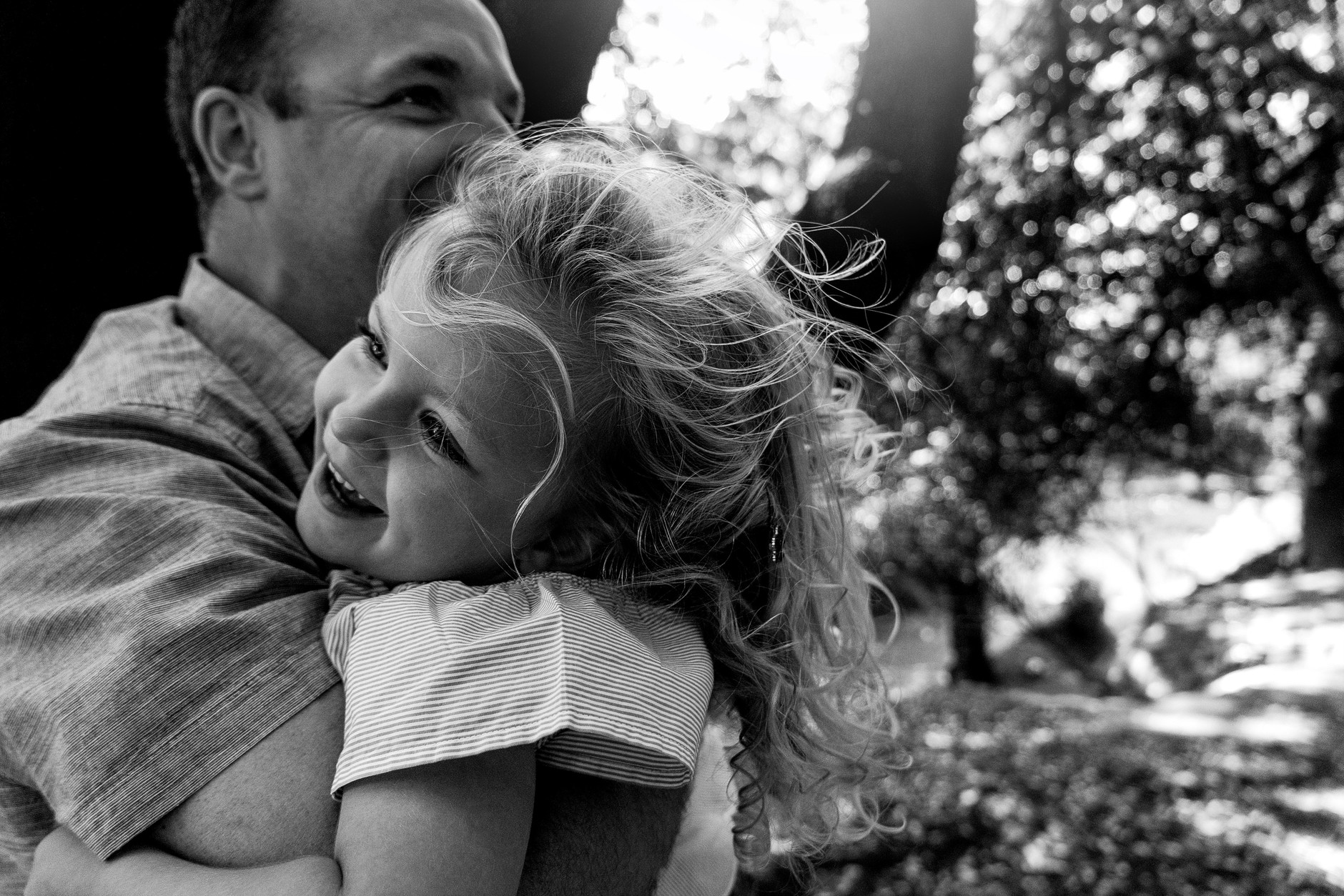 Dad hugging his laughing daughter