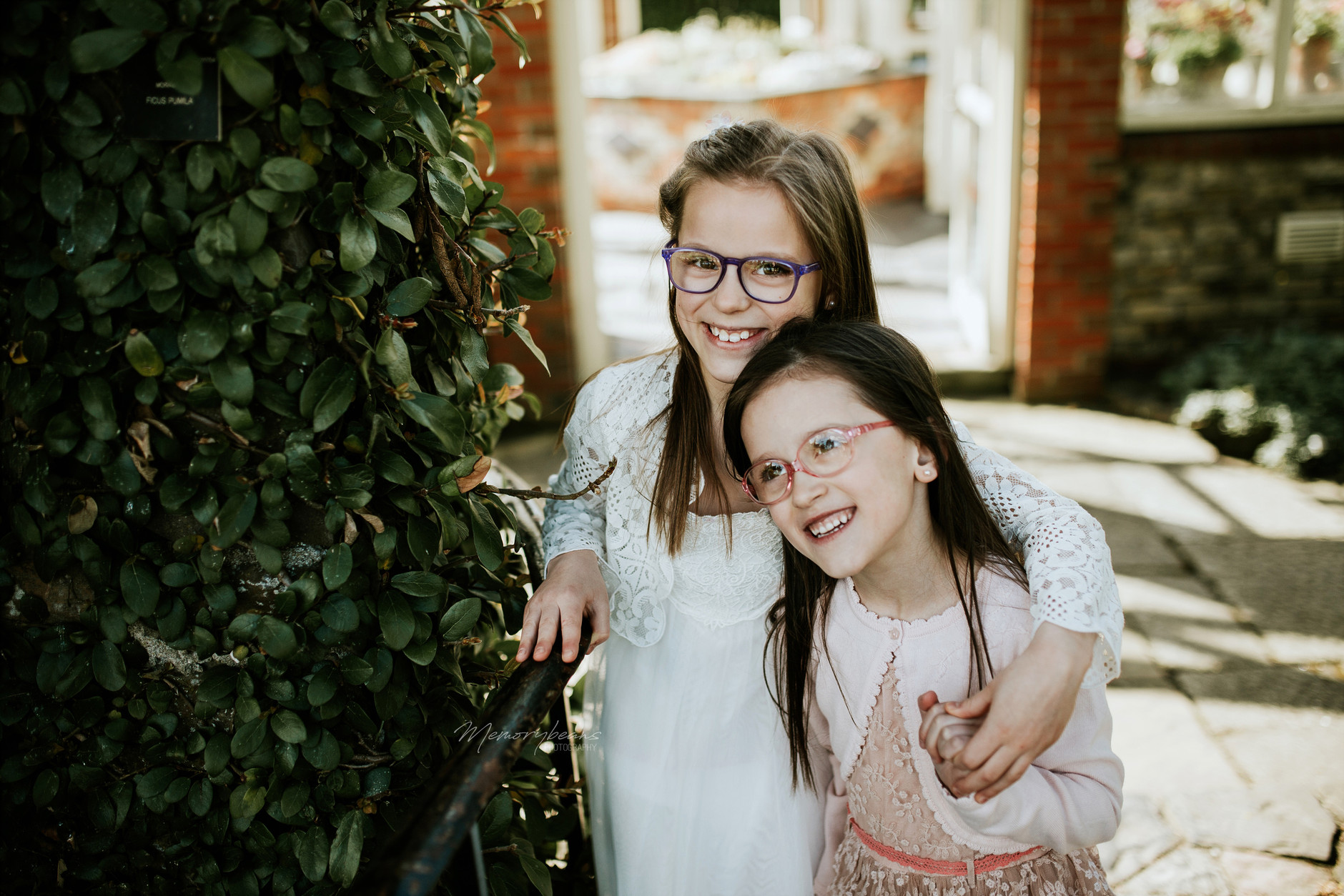 Two sisters posing for the camera after first holy communion