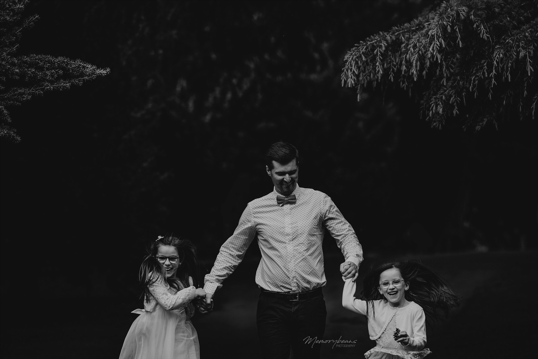 Father running with his two daughters on first holy communion: fun