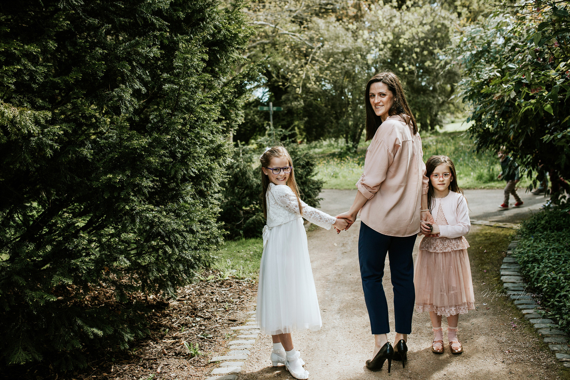 Mother and her two daughters walking on first communion