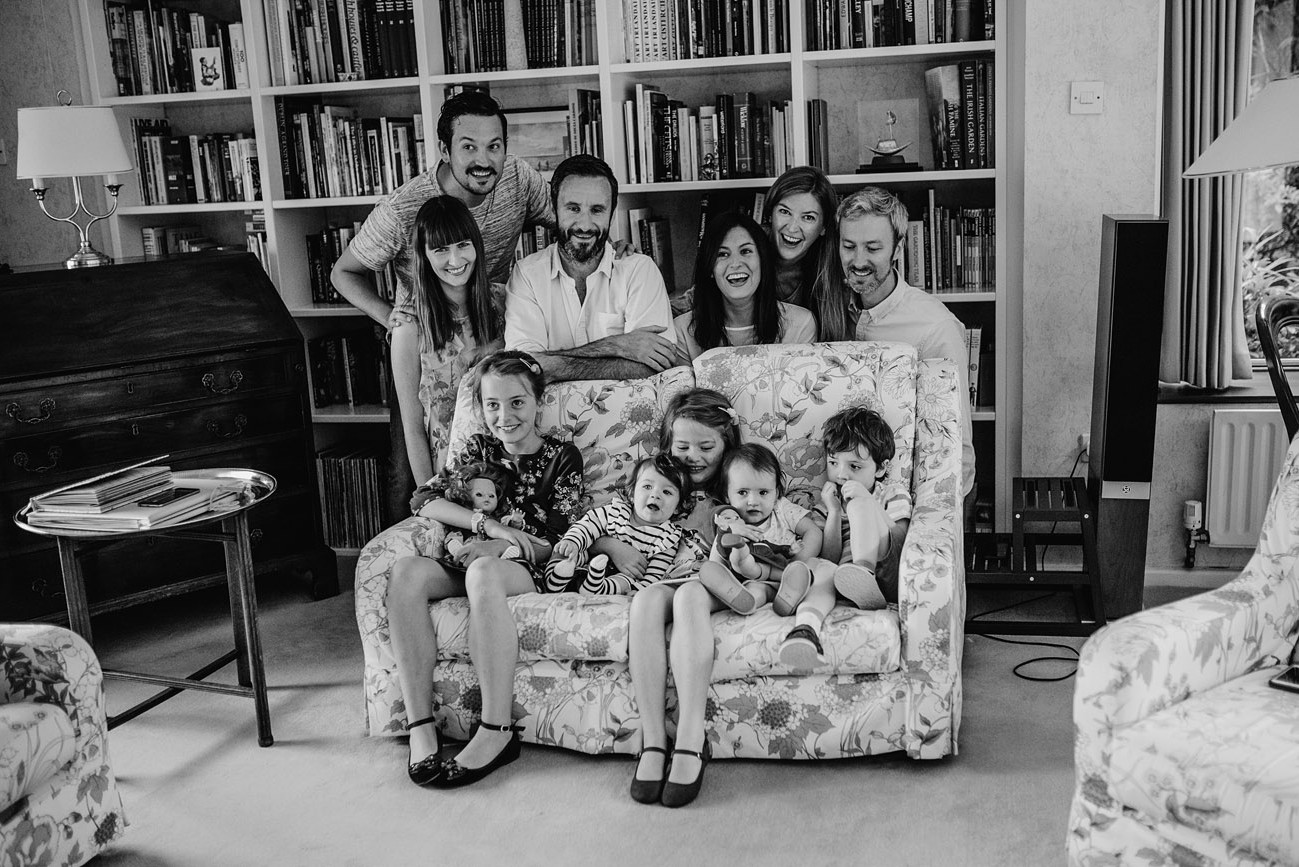 Large group family portrait at home of parents and children on the couch