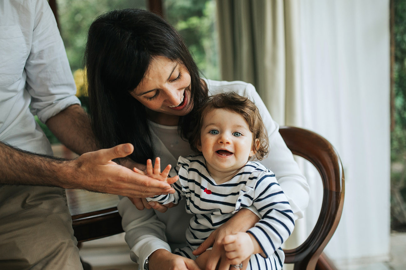 High five between father and baby laughing