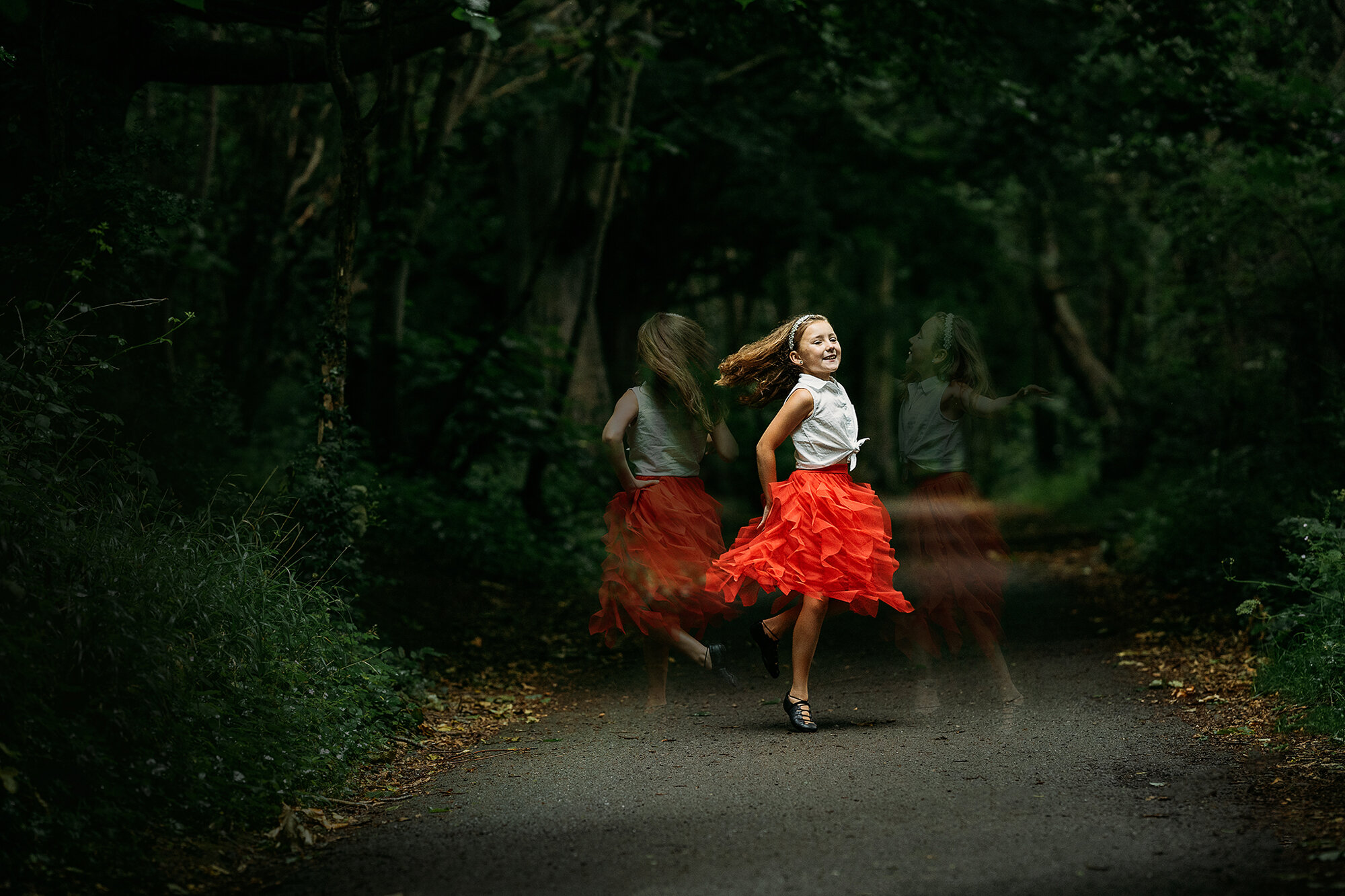 young dancer in red skirt twirling 