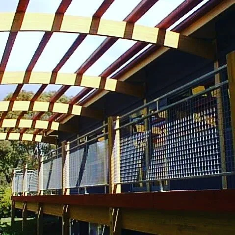 A 25 yo MCA architects project the joining of two demountable classrooms new cladding and new outside deck and pergola built for the local Council as a horticultural training facility that is still going strong, the curved rafters are laminated Cypre