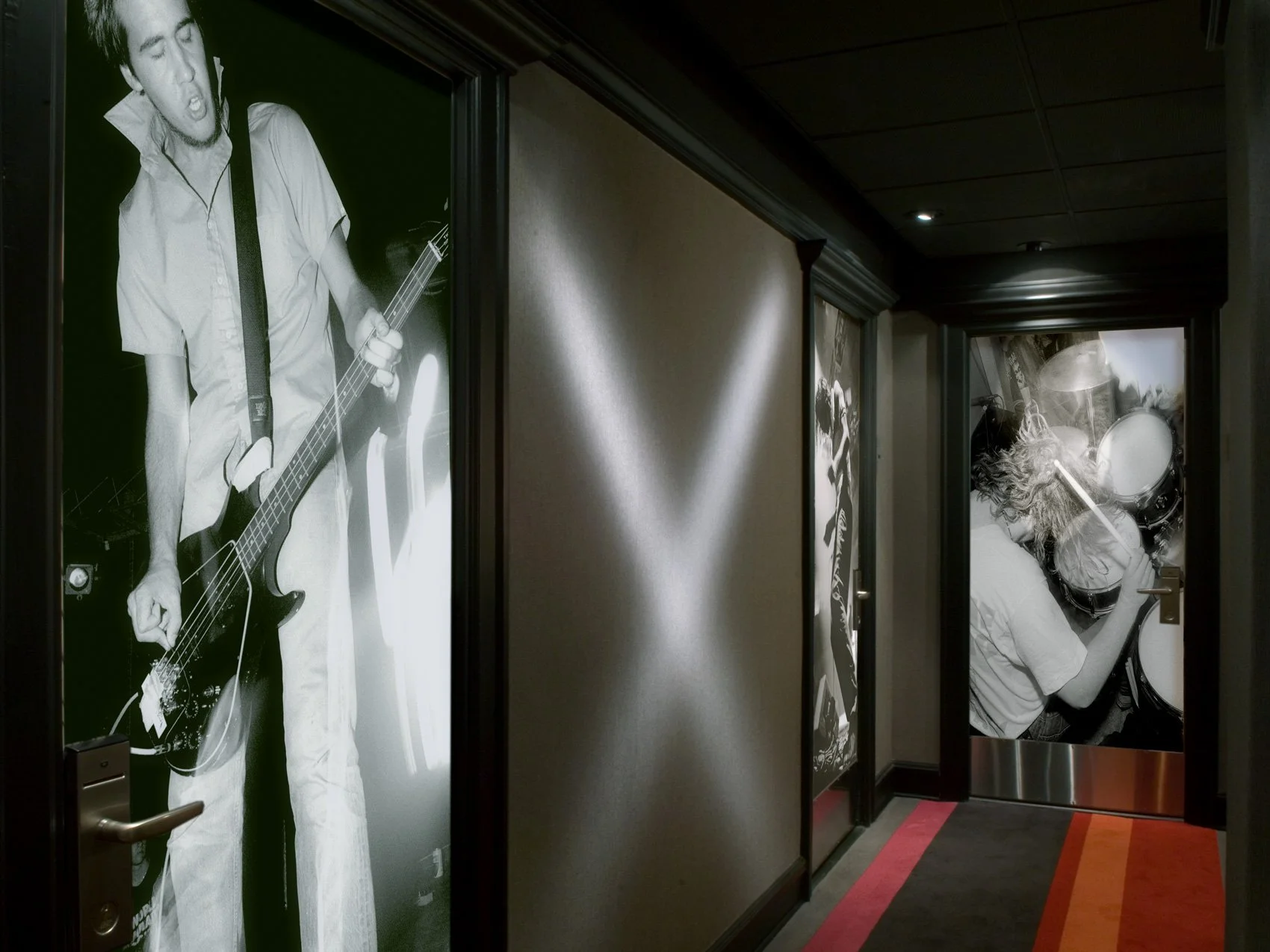 Hallway with large black-and-white photographs of musicians on the doors.