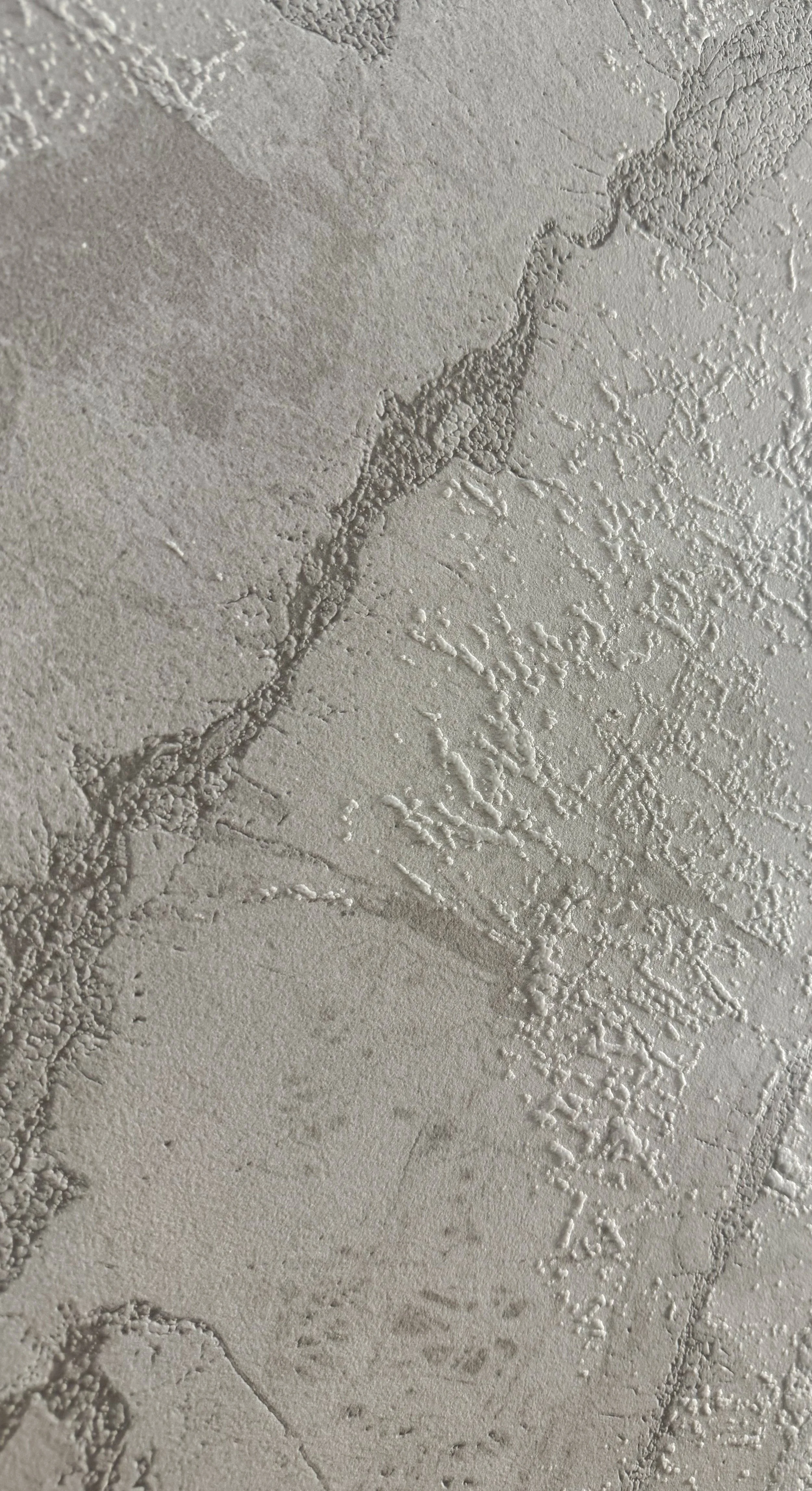 Glacier by plonc. — authored porcelain surface featuring layered geological relief inspired by aerial glacier formations, with pale mineral greys, restrained white tonal movement and subtle tactile texture.