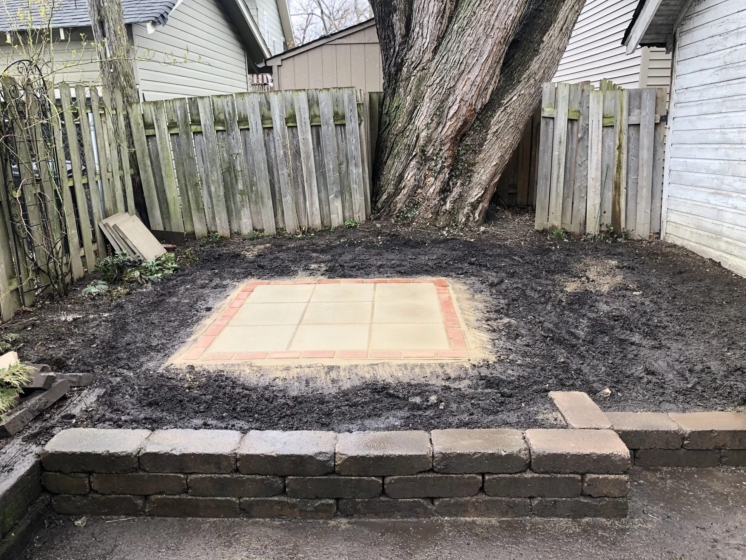  Heavy rains made for a muddy day but there was pooling on or around the new patio thanks to proper grading, soil remediation, and sound installation techniques.   More soil and mulch will be added and we’re currently designing the landscape treatmen