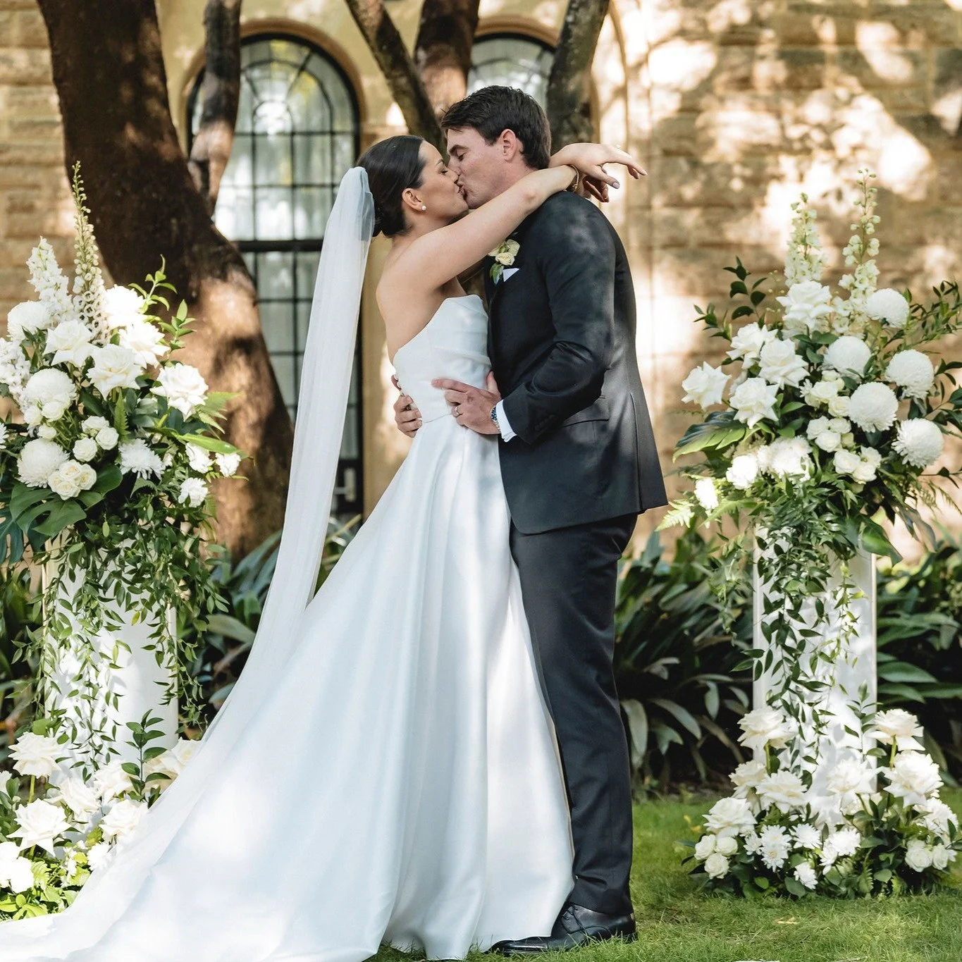 Ryan and Hannah's relaxed yet elegant wedding came to life in the beautiful UWA Sunken Gardens, with soft white and green florals blending perfectly with the natural surroundings. The outdoor ceremony and reception was set among lush lawns and leafy 