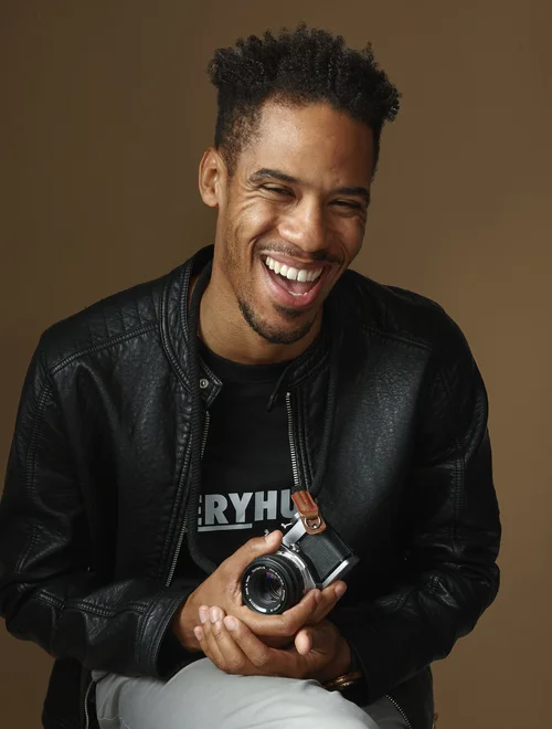 Mervyn Reid-Nelson, laughing, camera in hand