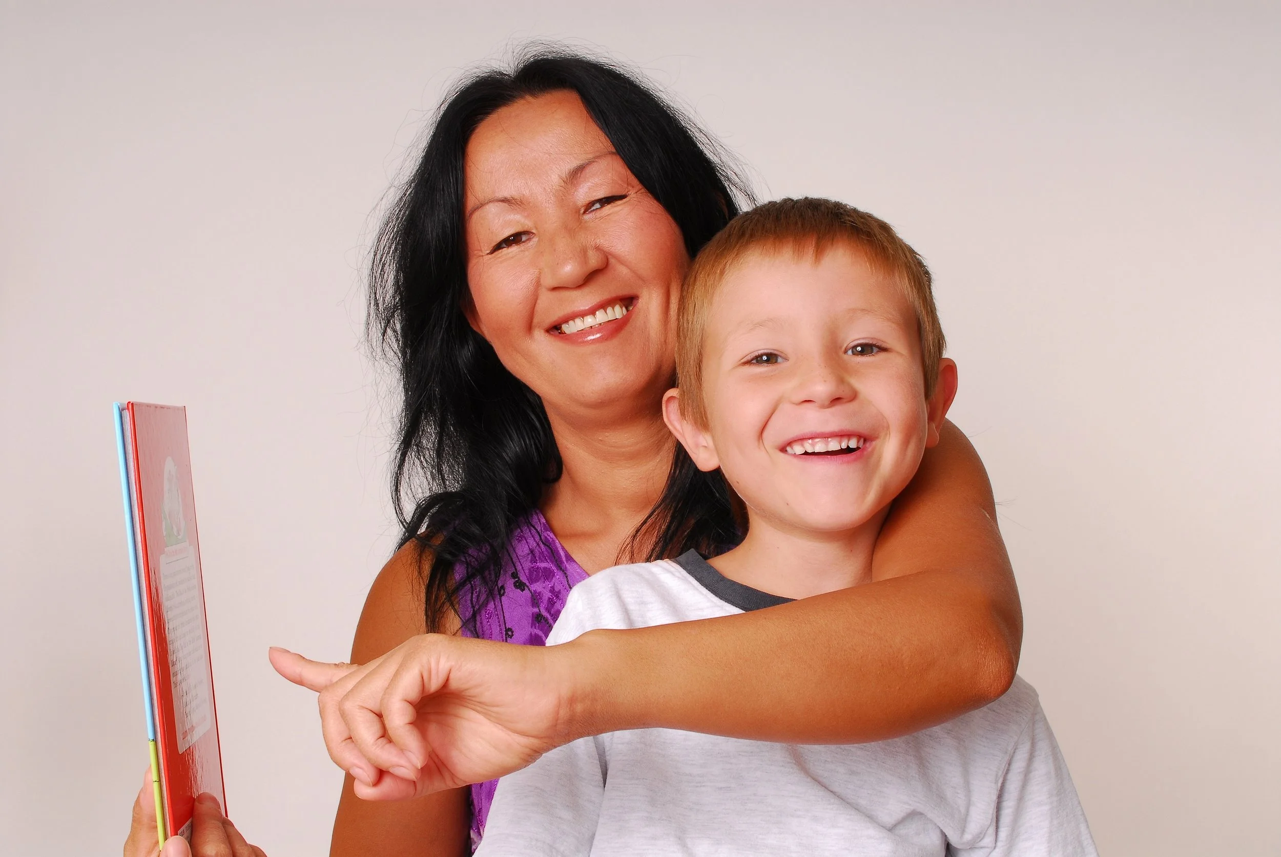 Happy woman and boy with big smiles.