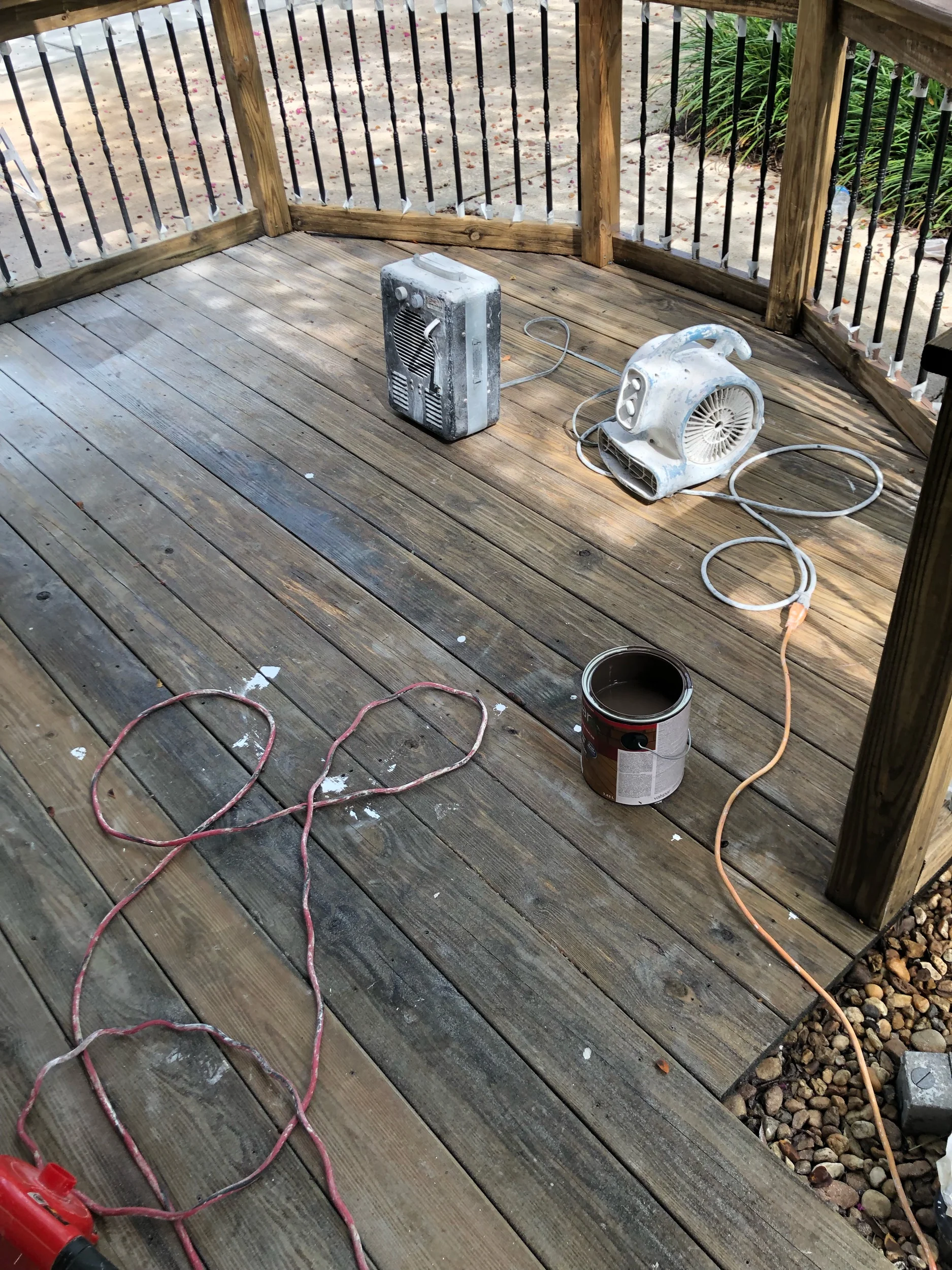Prepping to solid stain a wooden deck.
