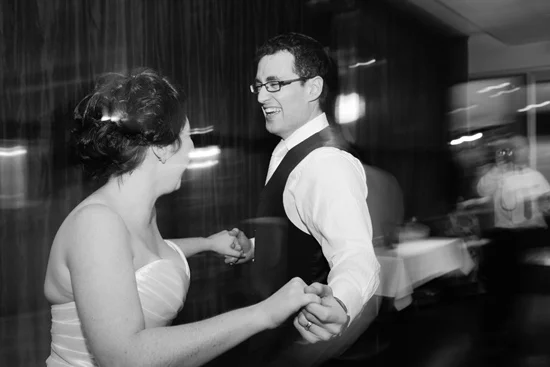 Black and white photo of couple jiving with first dance with background a blur