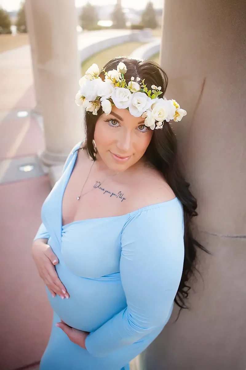 Expectant mother wearing a blue gown and floral crown during an outdoor maternity photography session in Indianapolis