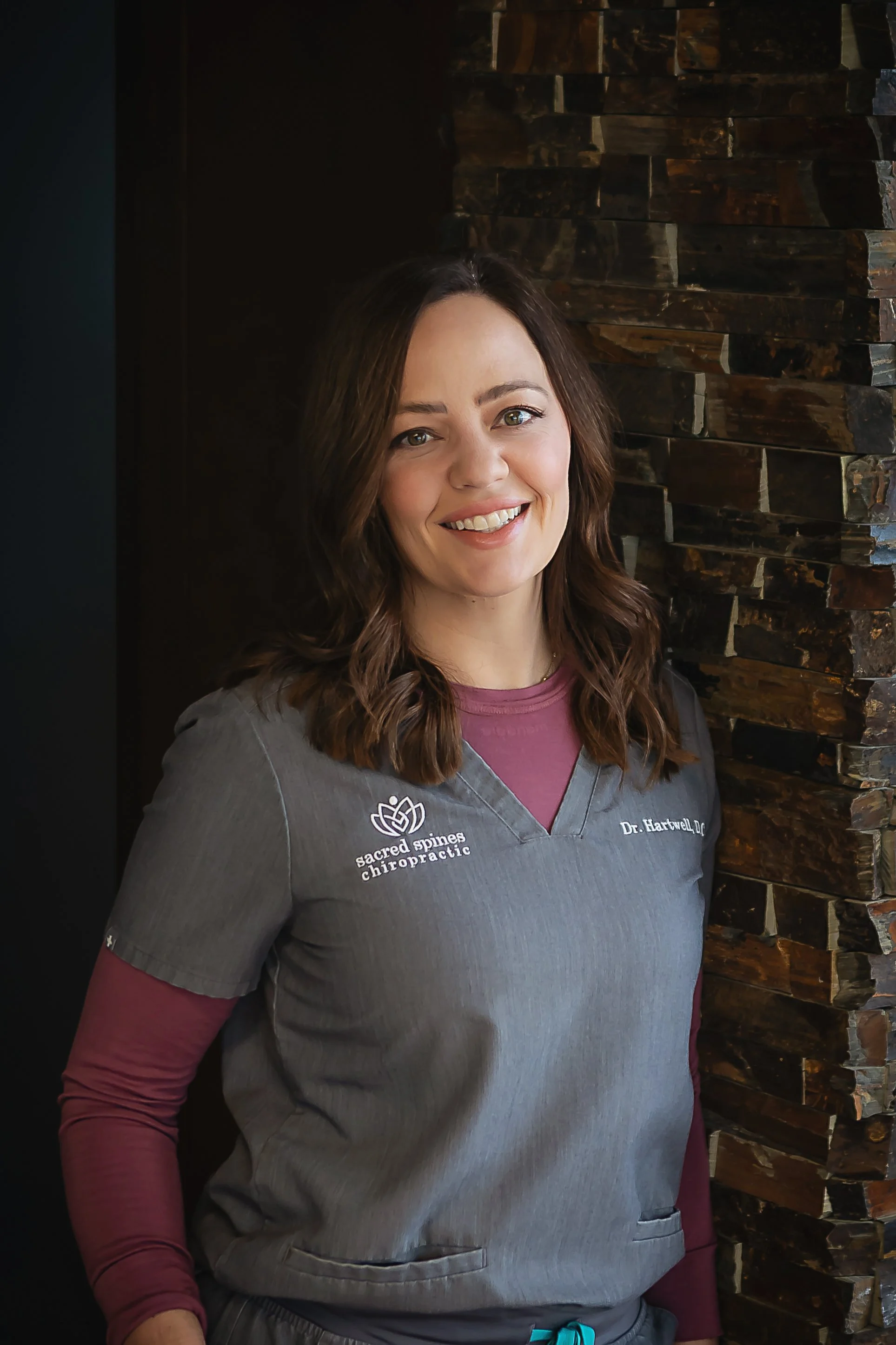 Dr. Kristen Hartwell performing a gentle pediatric chiropractic adjustment at Sacred Spines Chiropractic in Indianapolis.