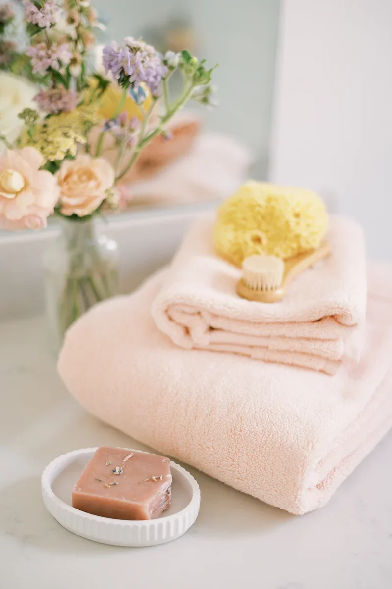 Close-up detail of florals in a milk bath, representing gentle posing guidance and relaxed movement during maternity photography.