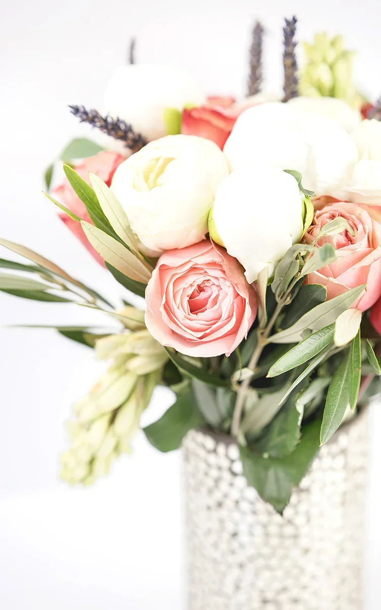 Fresh florals and greenery styled for a milk bath maternity photography session, adding a soft and romantic touch.