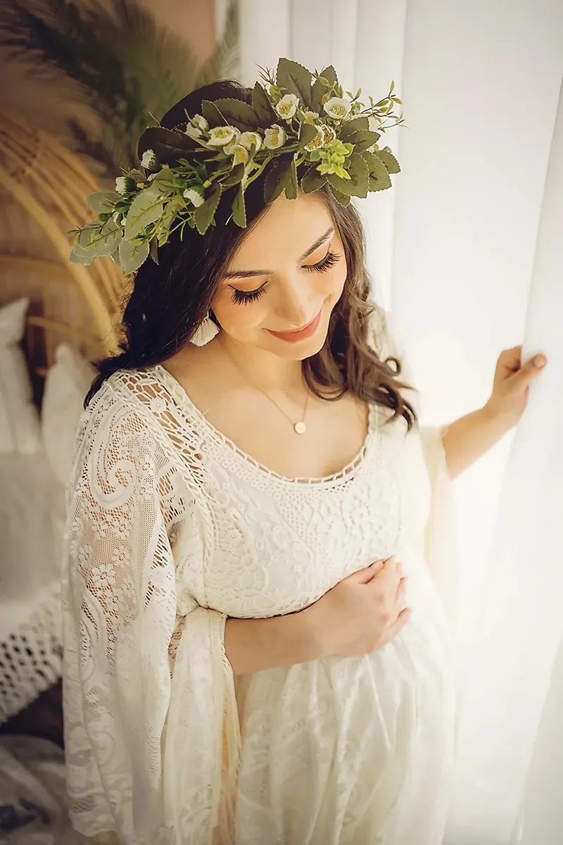 Smiling pregnant woman with ivory boho maternity dress and floral crown created by Memory Lane Photography Indy.