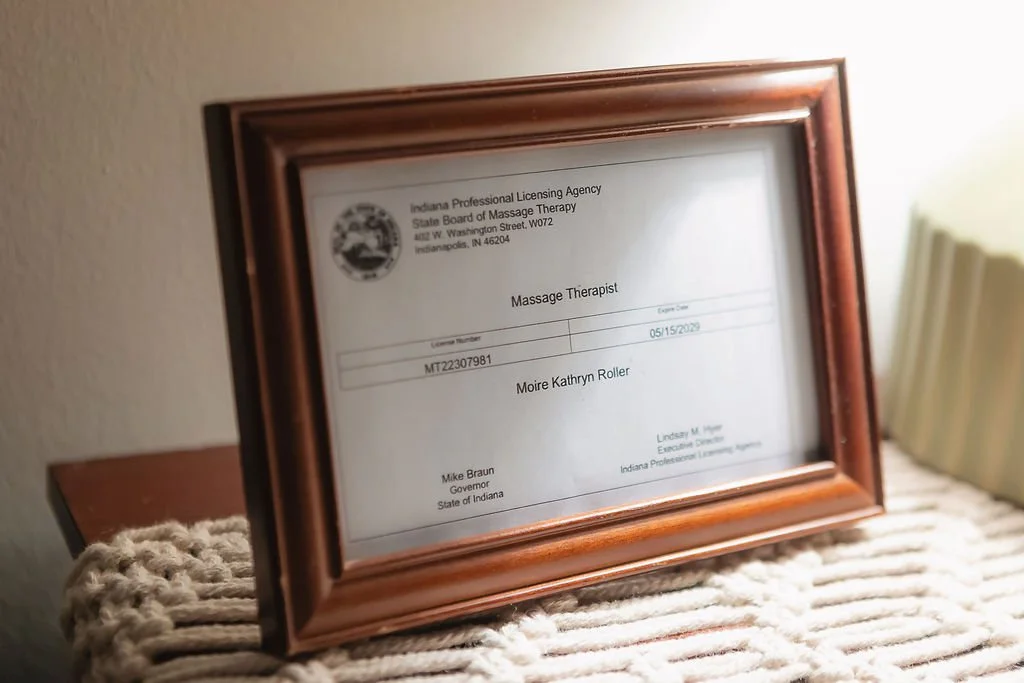 Framed photo of the license of a prenatal massage therapist in her Indianapolis office