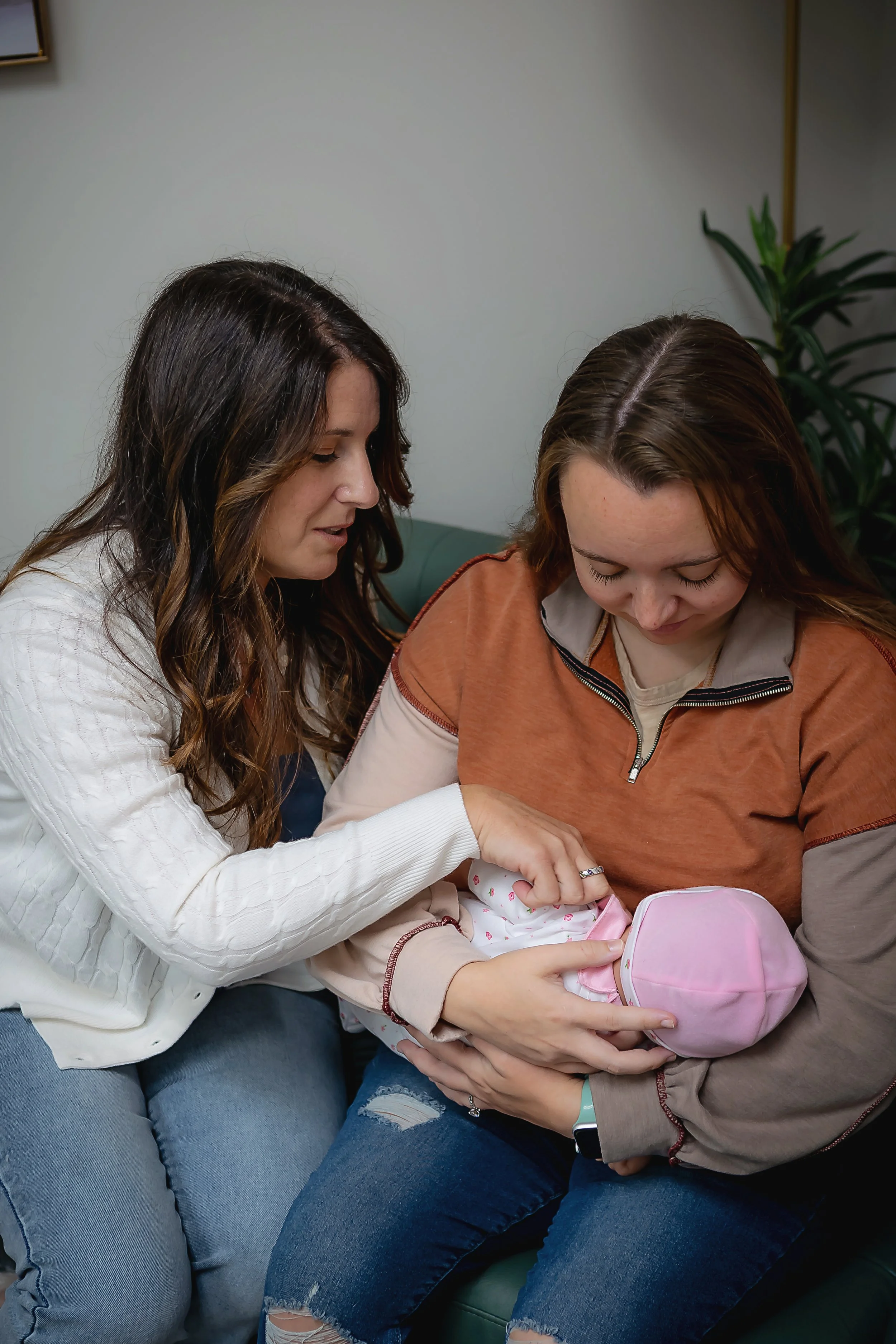 Lactation consultant in her office on the south side of Indianapolis coaching a new mother to breastfeed her baby