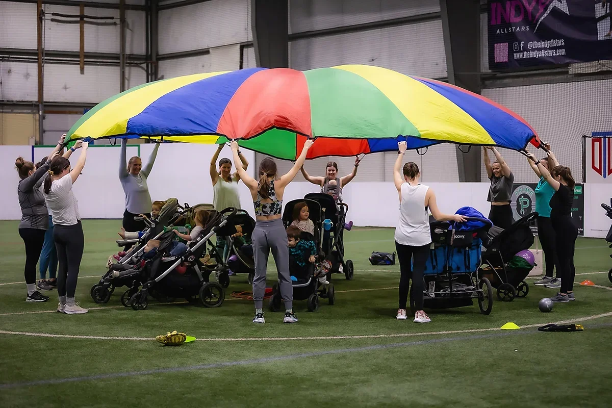 Group of local Indianapolis mothers meeting together while doing indoor stroller workouts.