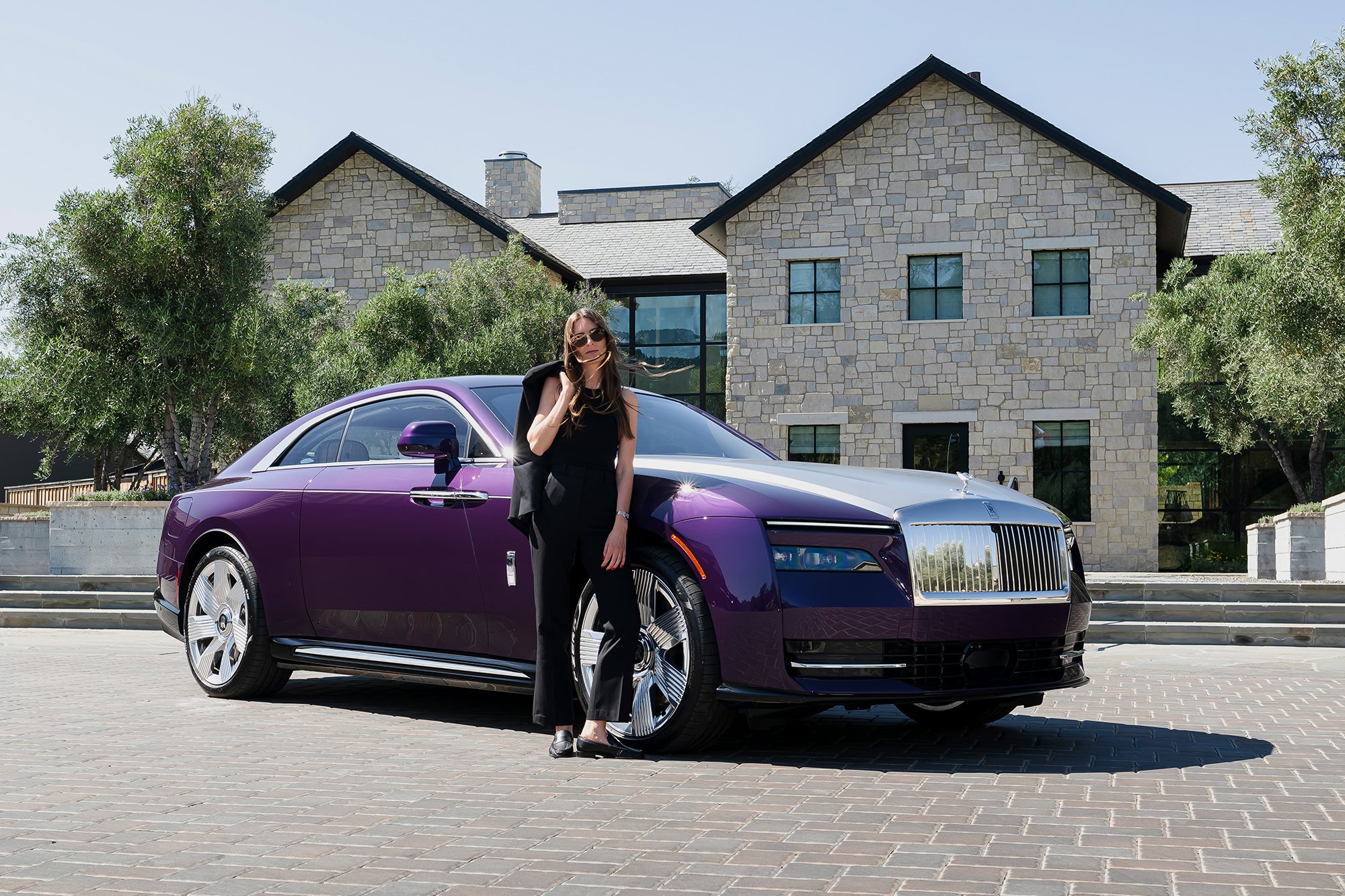 Britta Reineke, founder of ellectric standing next to the all-electric Rolls-Royce Spectre