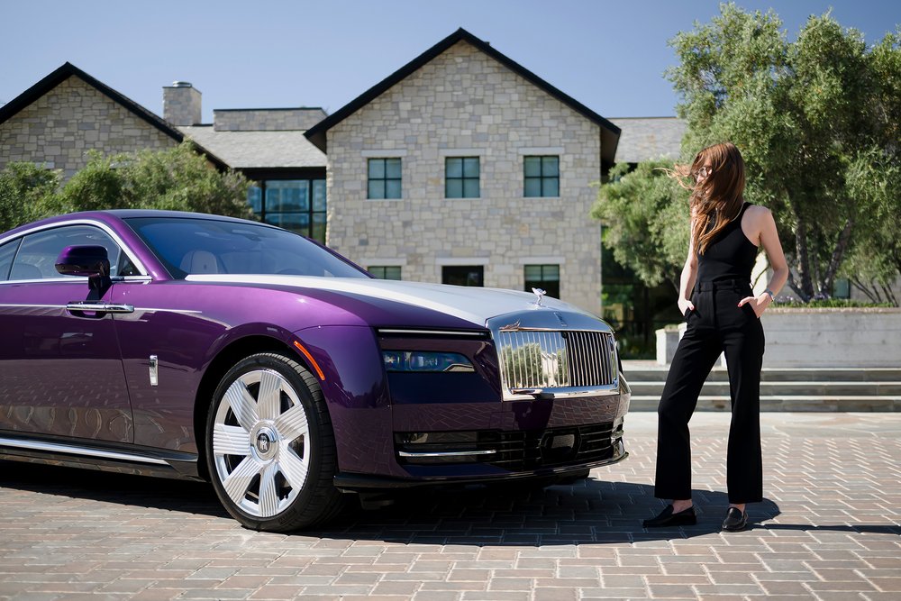 Britta Reineke, founder of ellectric standing in front of Pantheon grille of the all-electric Rolls-Royce Spectre