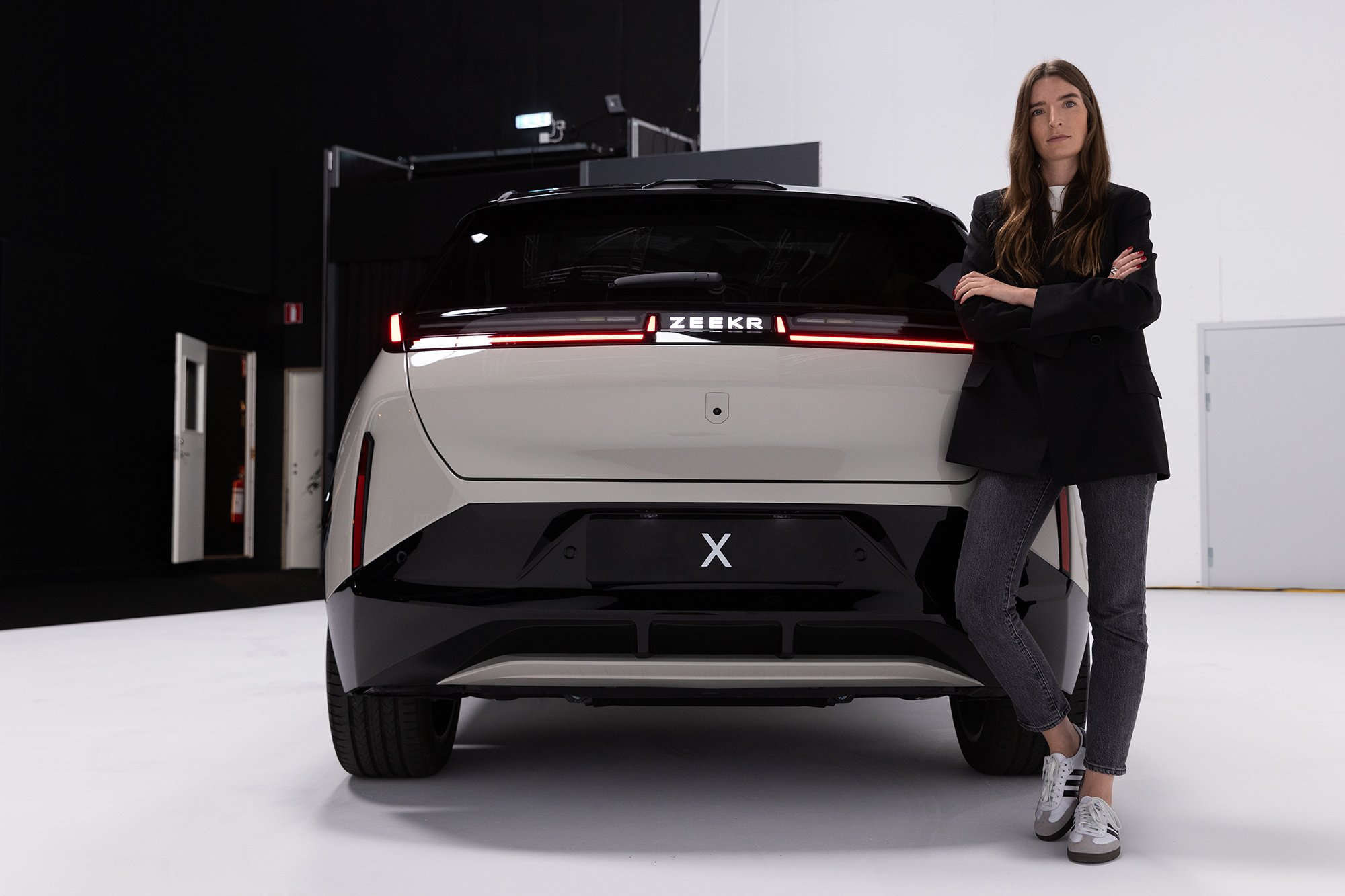 Britta Reineke, founder of ellectric showing the rear design of the all-electric ZEEKR X 