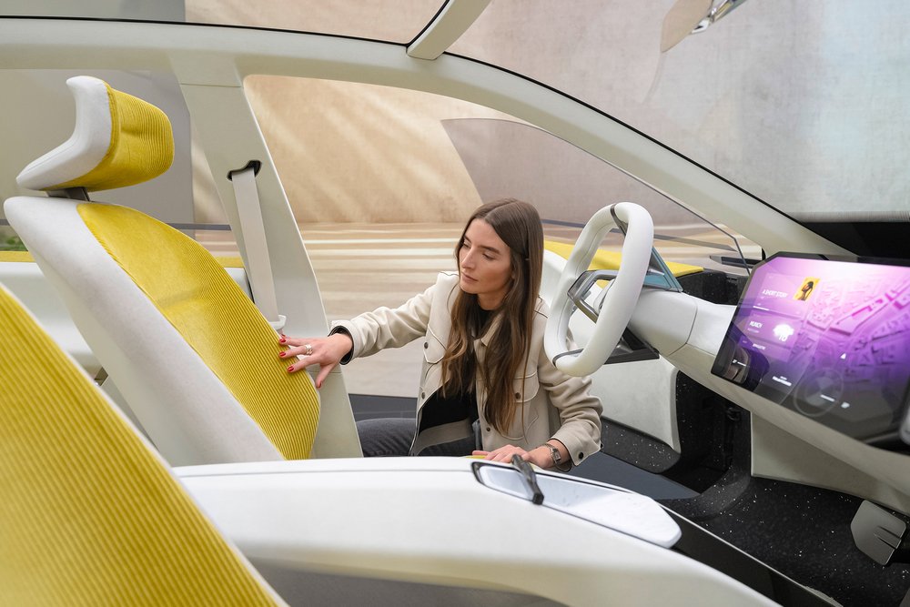 Britta Reineke, founder of ellectric checking out the seat design and corduroy material of the BMW Vision Neue Klasse