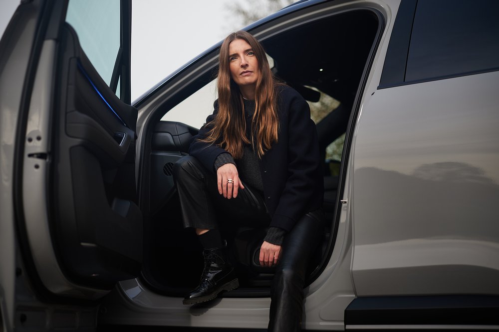 Britta Reineke, founder of ellectric, sitting on the driver's seat of the NIO EL6