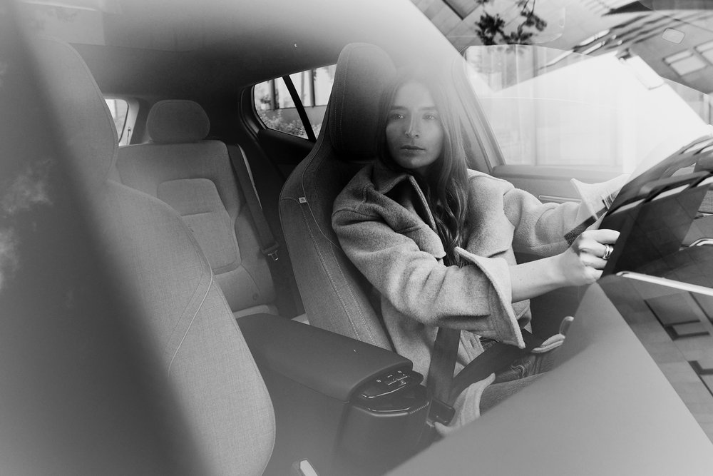 Britta Reineke, founder of ellectric sitting behind the wheel of the Volvo EX30