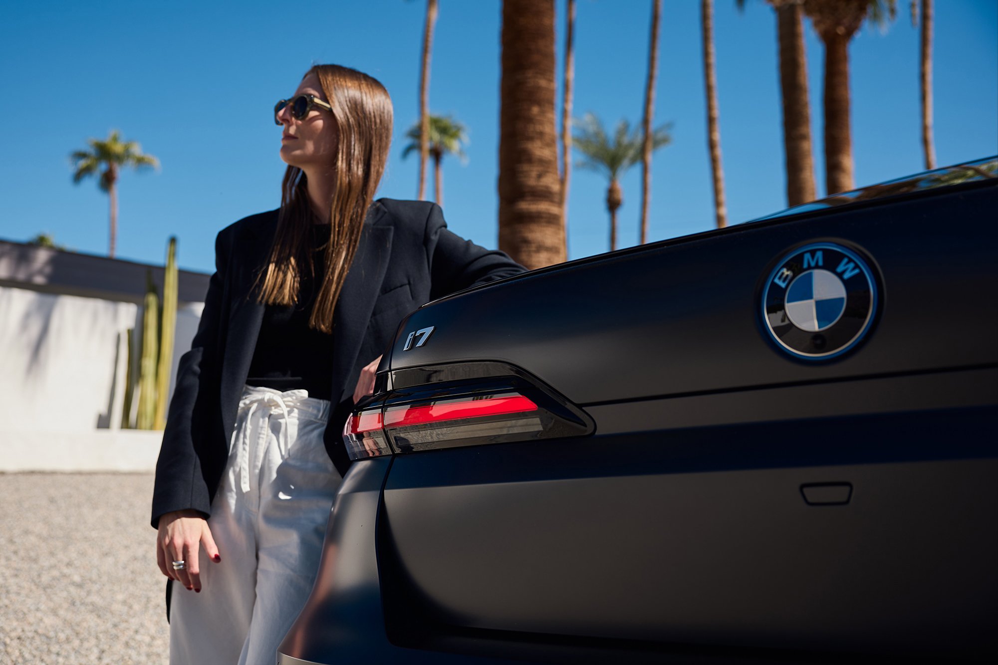 Britta Reineke, founder of ellectric leans at the rear of the BMW i7