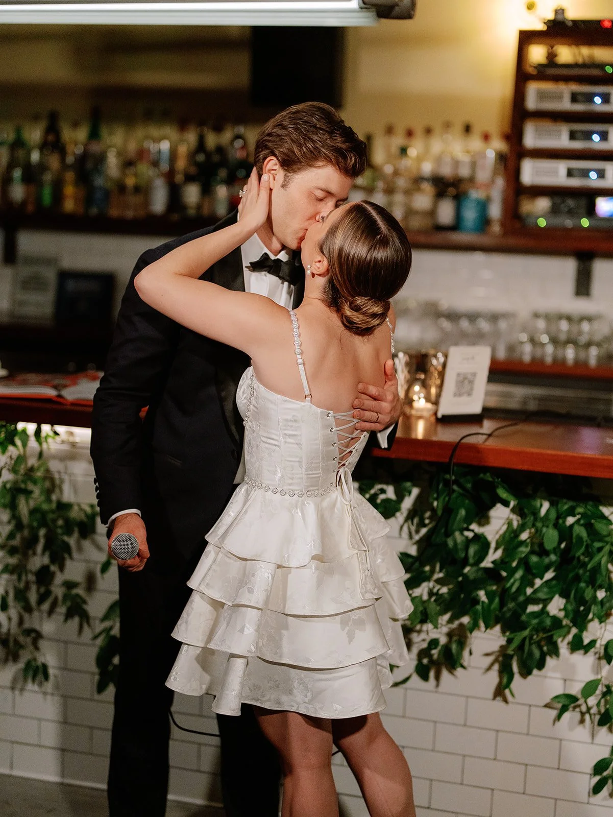 wedding-bar-kiss-bride-and-groom-styled-greenery.jpg.jpg