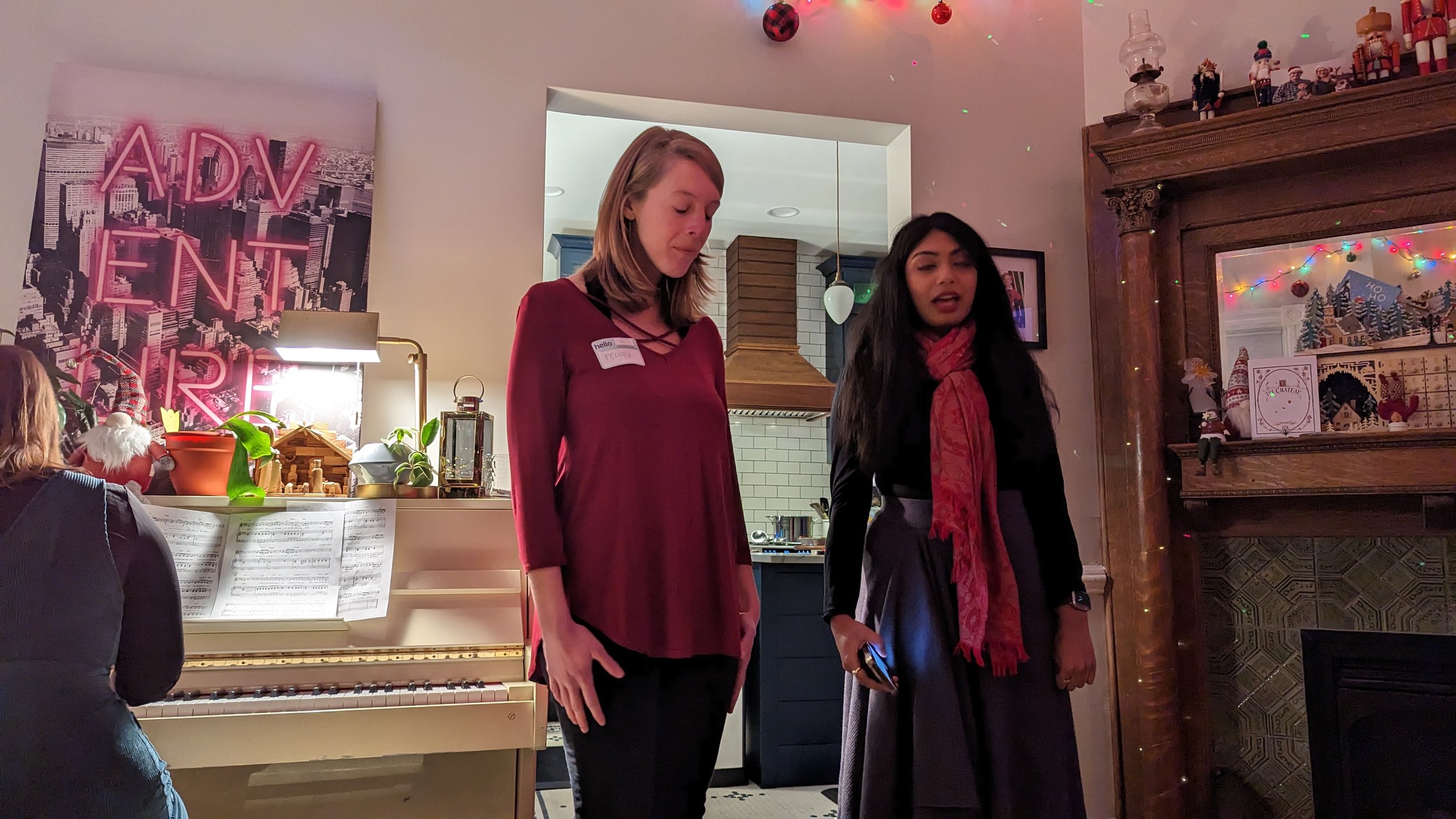    Mezzo, Peggy Kerr, and Alto, Naina Kamath, singing a piano accompanied number at a private Christmas party Noteworthy performed at in 2022.   