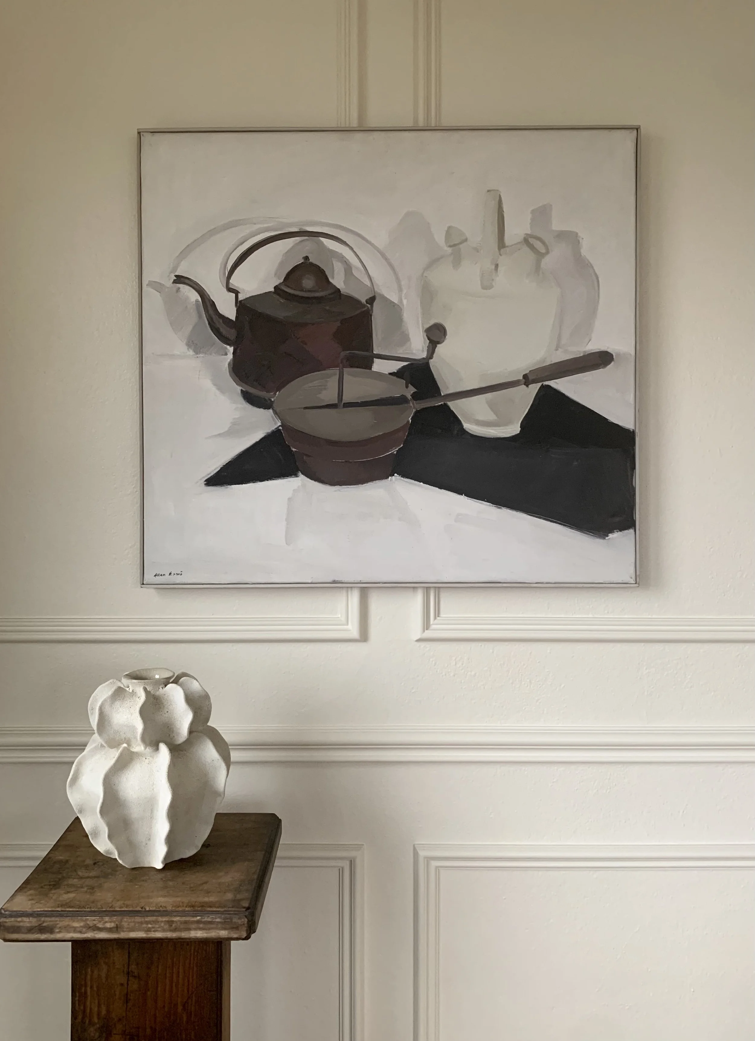 ‘Kitchen Still Life’ (ca. 1960s) by Allan Erwo hanging on a wall above a handbuilt ceramic vase.