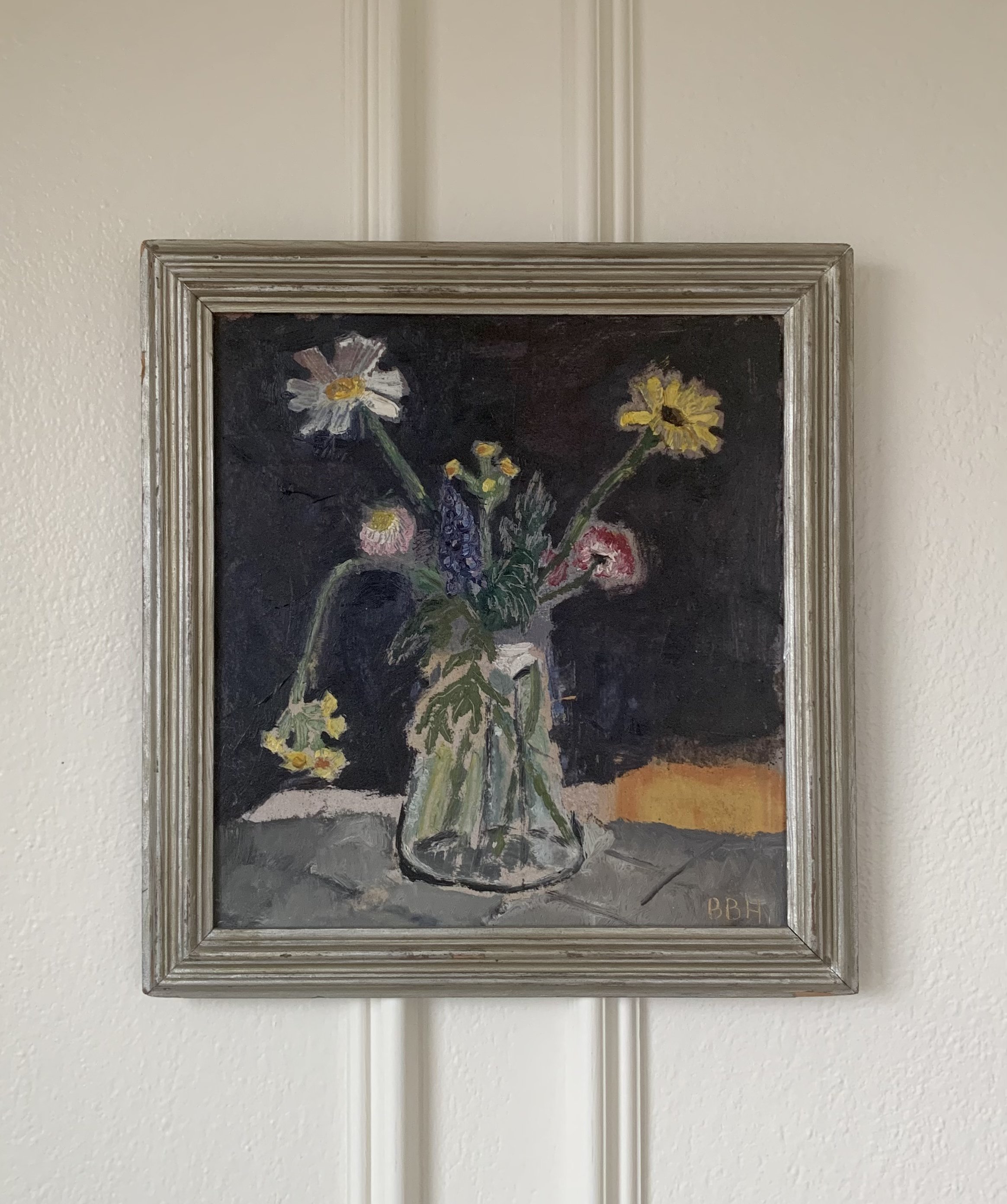 ‘Spring Bouquet Still Life’ (ca. 1950s), a framed still life oil painting by Bjorn Halling showing a glass vase on a tabletop with several flowers.