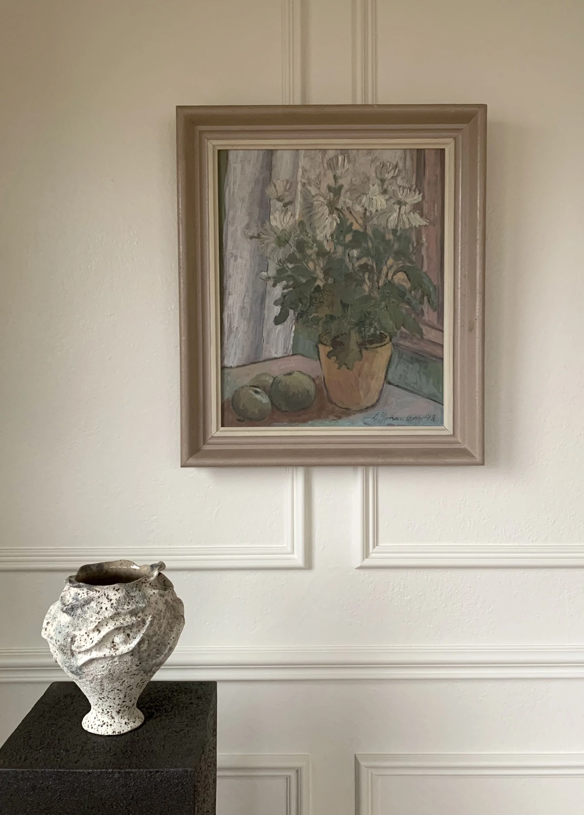 Detail of ‘Potted Daisies (Still Life)’ (1948), a framed oil painting showing the painting hanging on a wall in a room.