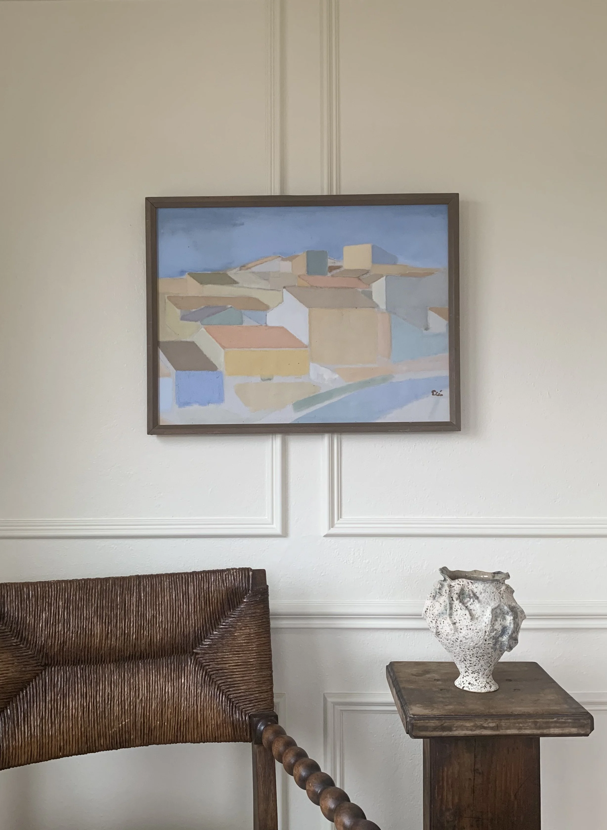 Detail of ‘Rooftop Cityscape’ (ca. 1950s) by Ingvar Elen, showing the painting hanging on wall in a room.