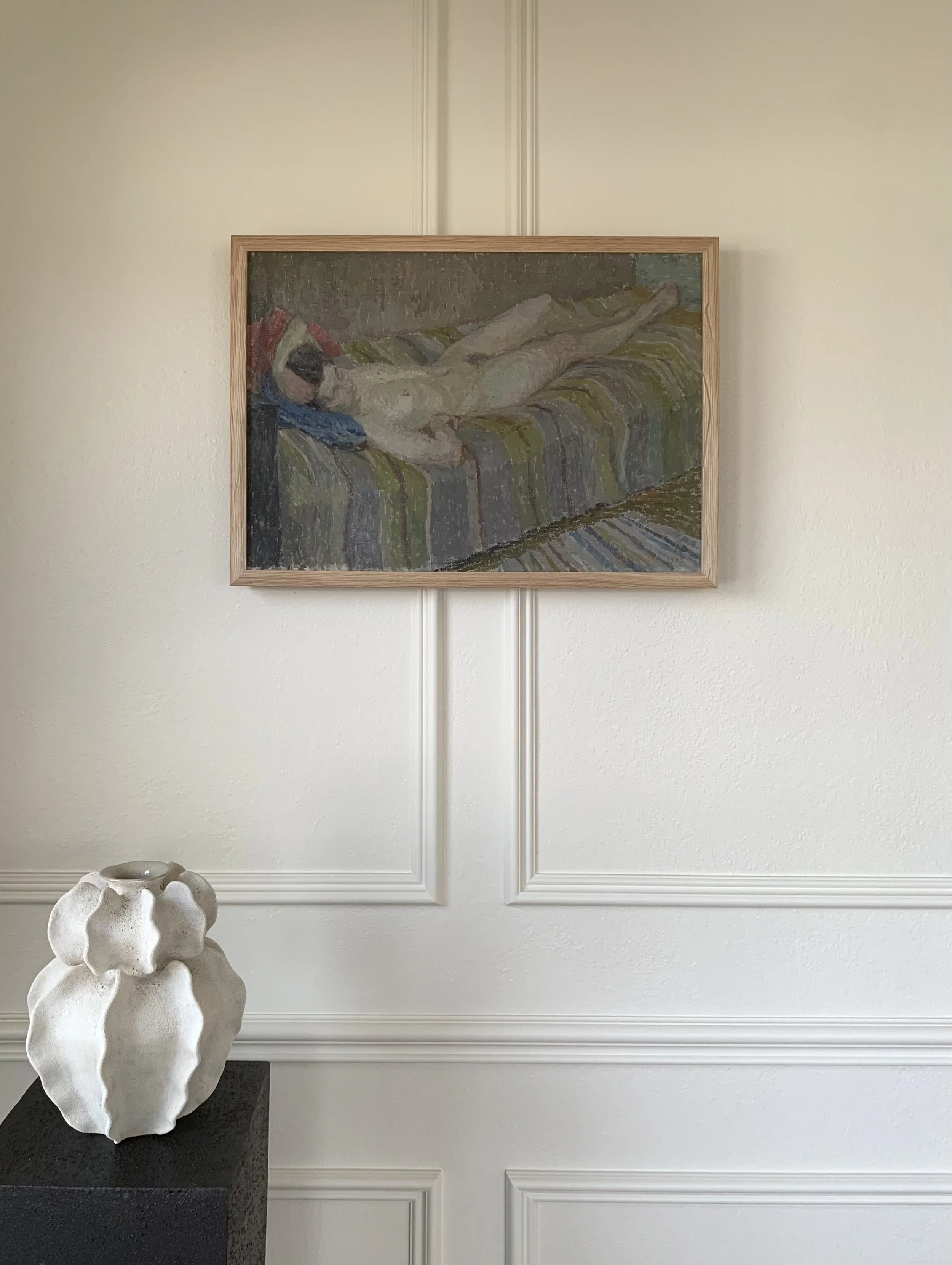 Detail of ‘Reclining Woman’ (1945) by Sune Tjellander, a framed oil painting showing the painting hanging on a wall in a room.