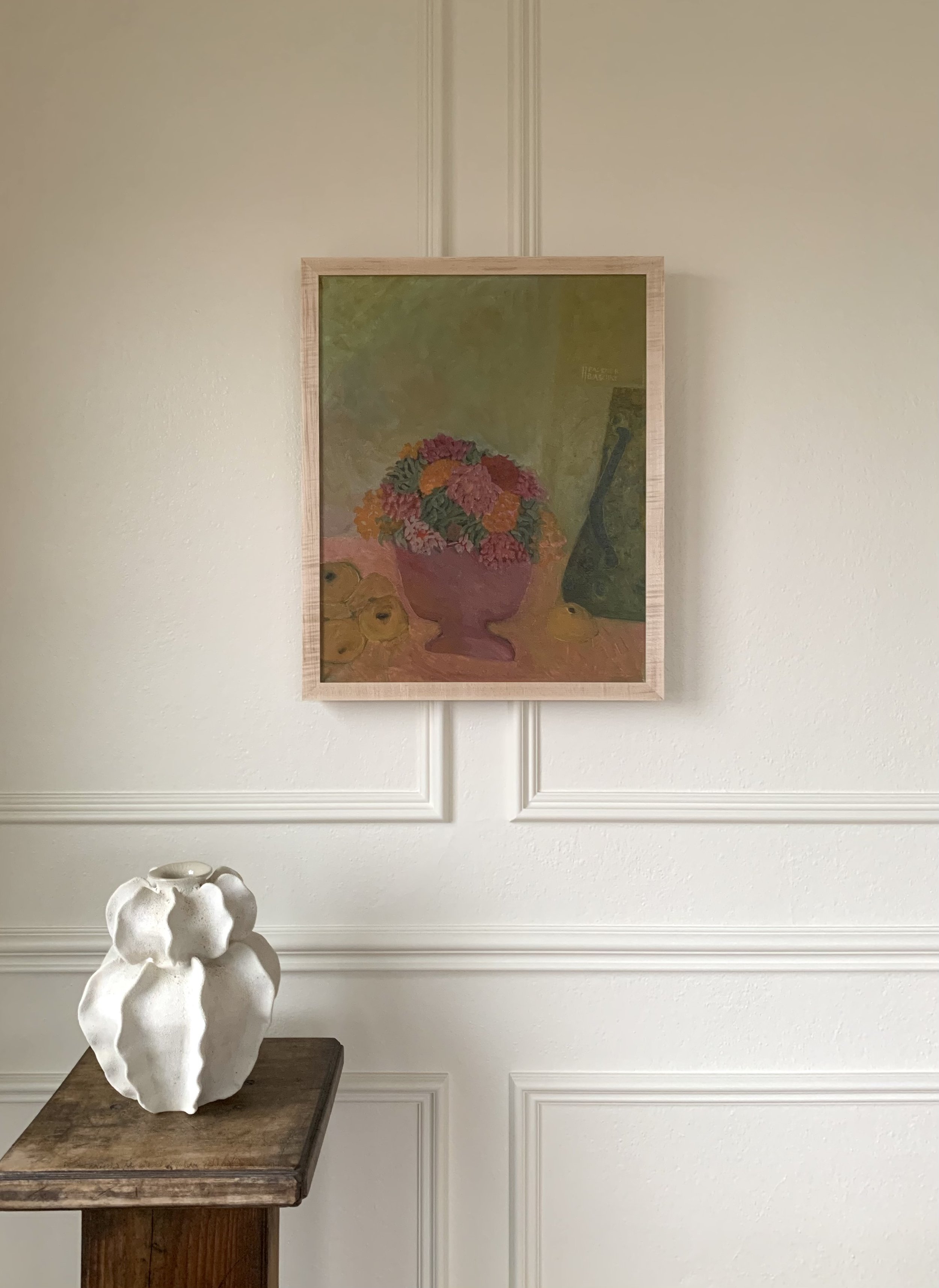 Detail of ‘Floral Still Life with Fruit’ (1982) by Helga Radener-Blaschke, a framed oil painting hanging on a wall in a room.